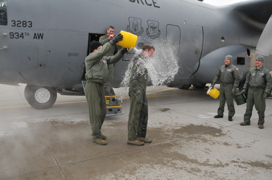Chief Master Sgt. Mark Hartnett, 96th Airlift Squadron flight engineer, is splashed down in sub zero temperatures after his final flight. Chief Harnett is retiring after 33 years of Service.  (Air Force Photo/Tech. Sgt. Bob Sommer)