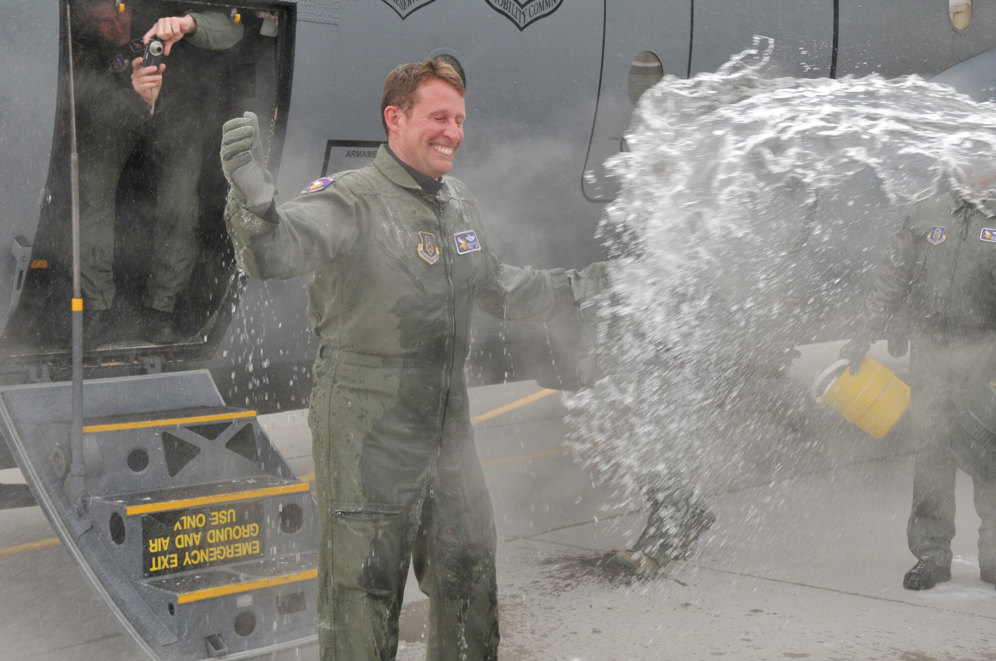 Chief Master Sgt. Mark Hartnett, 96th Airlift Squadron flight engineer, is splashed down in sub zero temperatures after his final flight. Chief Harnett is retiring after 33 years of Service.  (Air Force Photo/Tech. Sgt. Bob Sommer)