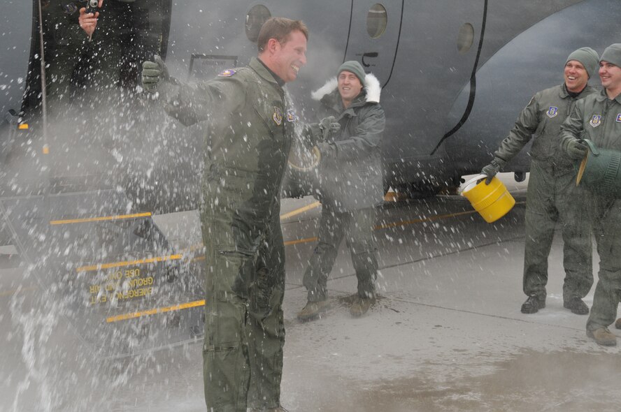 Chief Master Sgt. Mark Hartnett, 96th Airlift Squadron flight engineer, is splashed down in sub zero temperatures after his final flight. Chief Harnett is retiring after 33 years of Service.  (Air Force Photo/Tech. Sgt. Bob Sommer)