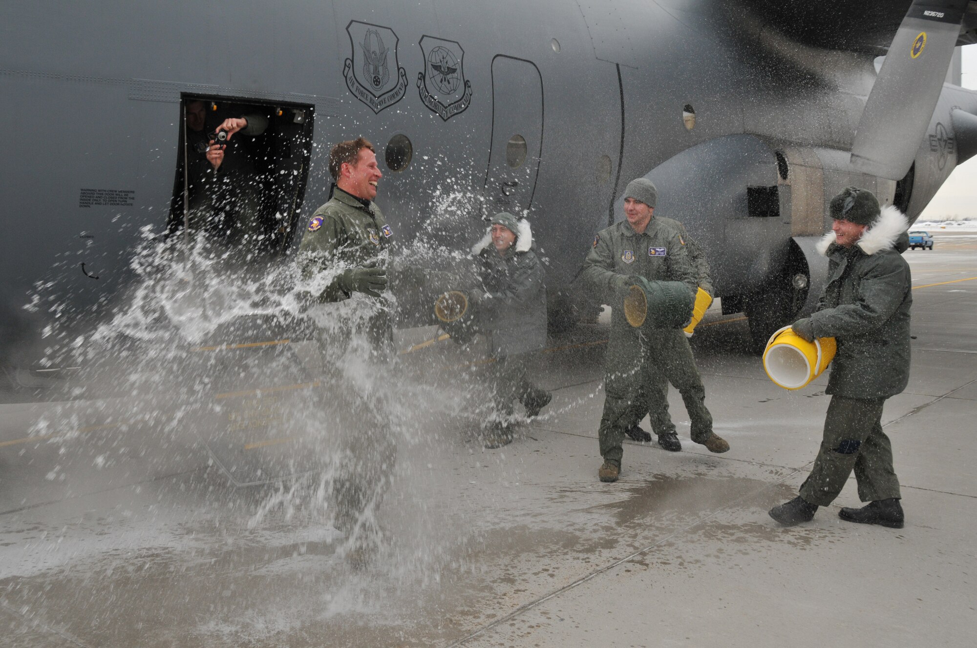 Chief Master Sgt. Mark Hartnett, 96th Airlift Squadron flight engineer, is splashed down in sub zero temperatures after his final flight. Chief Harnett is retiring after 33 years of Service.  (Air Force Photo/Tech. Sgt. Bob Sommer)