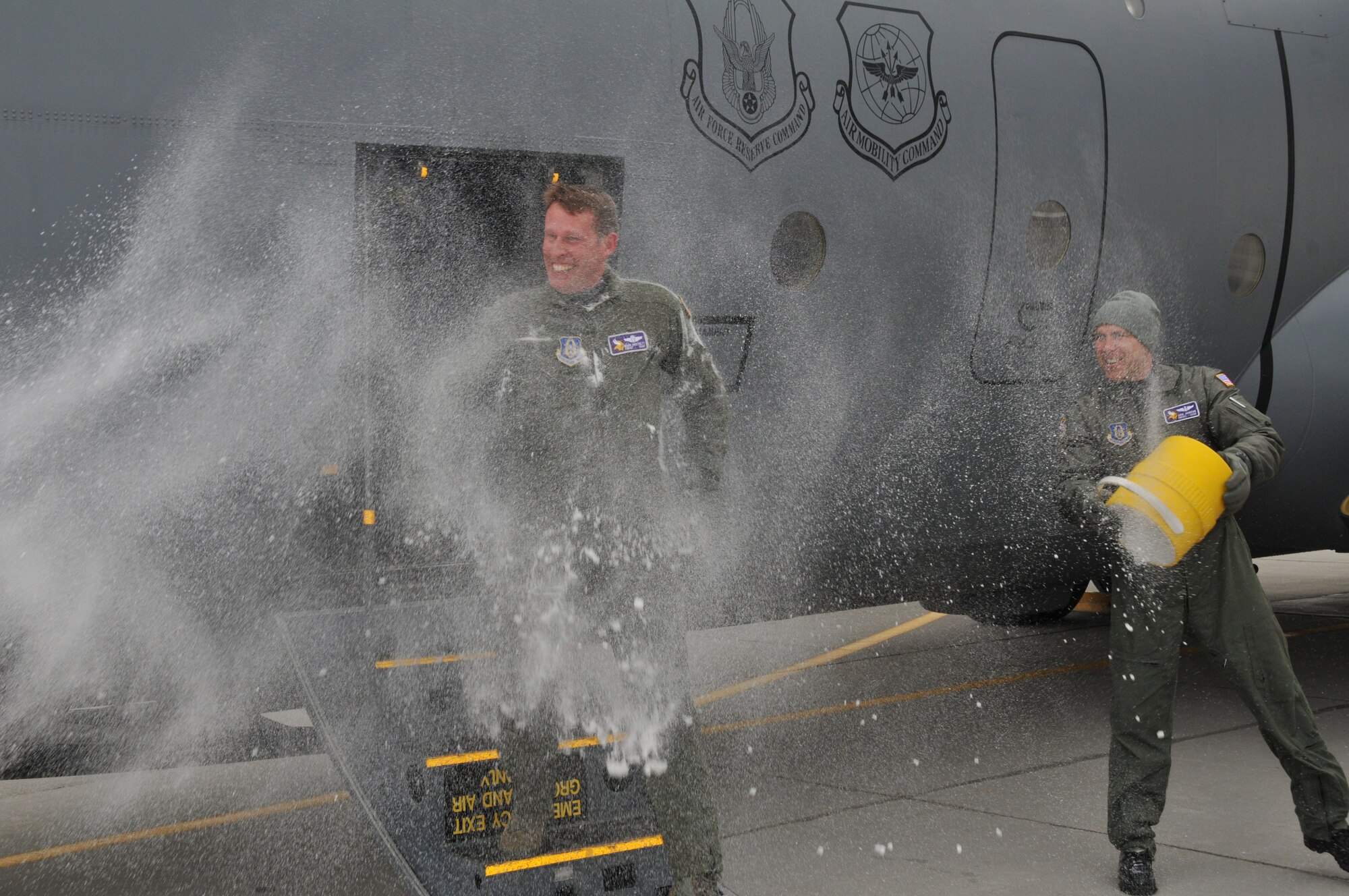 Chief Master Sgt. Mark Hartnett, 96th Airlift Squadron flight engineer, is splashed down in sub zero temperatures after his final flight. Chief Harnett is retiring after 33 years of Service.  (Air Force Photo/Tech. Sgt. Bob Sommer)