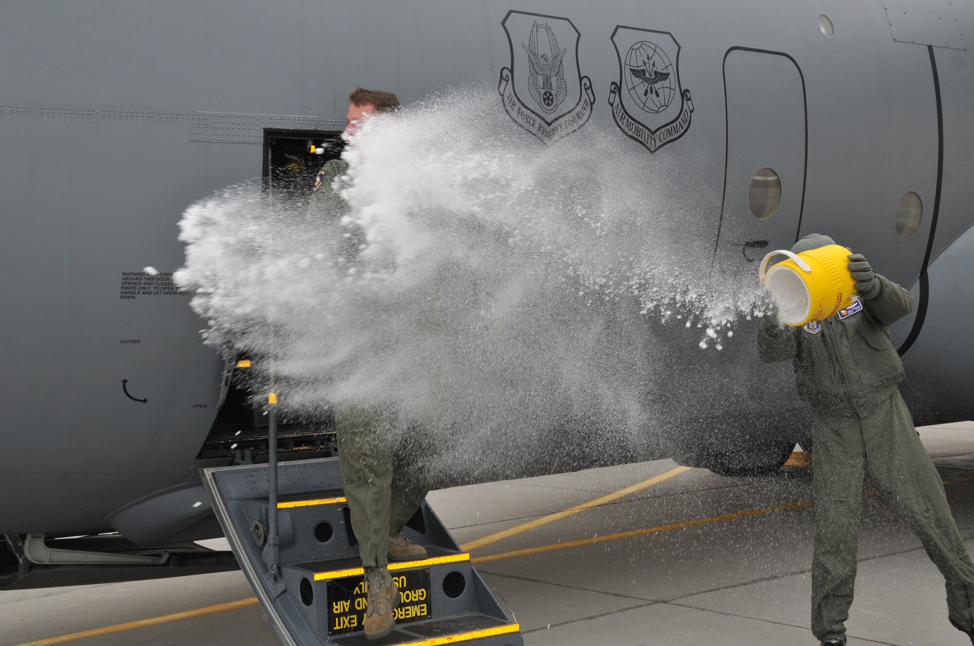 Chief Master Sgt. Mark Hartnett, 96th Airlift Squadron flight engineer, is splashed down in sub zero temperatures after his final flight. Chief Harnett is retiring after 33 years of Service.  (Air Force Photo/Tech. Sgt. Bob Sommer)