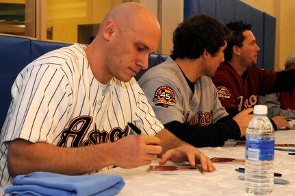 Clint Barmes, Brett Wallace and Chris Johnson, Houston Astros baseball players, sign autographs for fans at the Rambler Fitness Center at Randolph Air Force Base, Texas, as a part of the Astros 2011 Caravan Jan. 20. (U.S. Air Force photo/Amn Alexis Siekert)