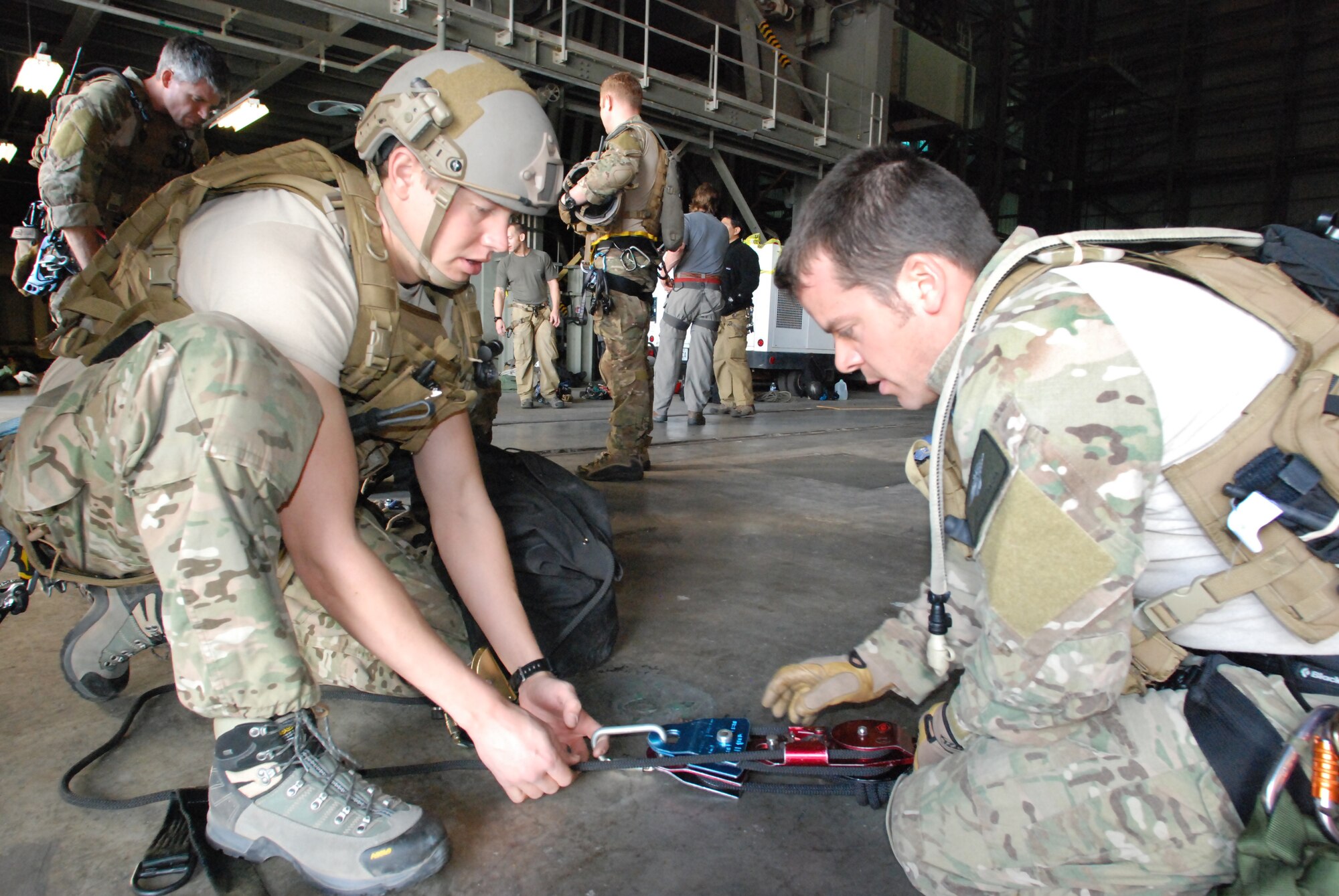 CAPE CANAVERAL AIR FORCE STATION, Fla. - Senior Airman Eric Humphrey, reserve pararescueman from Davis-Monthan Air Force Base, Ariz., and Master Sgt. Joe Traska, reserve pararescueman with the 920th Rescue Wing, Cocoa Beach, Fla., prepare their ropes and pulleys for rescue training. The training, by ROCO Rescue, is high-angle, high-altitude and confined space rescue refresher for the PJs and combat rescue officers.   (U.S. Air Force photo/Staff Sgt. Leslie Kraushaar)