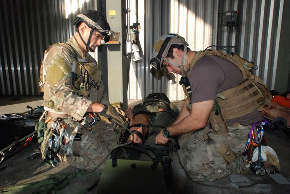CAPE CANAVERAL AIR FORCE STATION, Fla. - Master Sgt. Christopher Lais, reserve pararescueman from the 920th Rescue Wing, Fla., and Senior Airman Dan Duhon, reserve PJ from Davis Monthan Air Force Base, Ariz., secure Oscar, "the victim," to a SKEDCO - a portable, flexible plastic mode of transporting an injured person. Once finished here, the PJs make their way up to the highest point in the empty rocket complex and start their rescue efforts, by hoisting Oscar straight up hundreds of feet in the air. The training, by ROCO Rescue, is high-angle, high-altitude and confined space rescue refresher for the PJs and combat rescue officers.  (U.S. Air Force photo/Staff Sgt. Leslie Kraushaar)