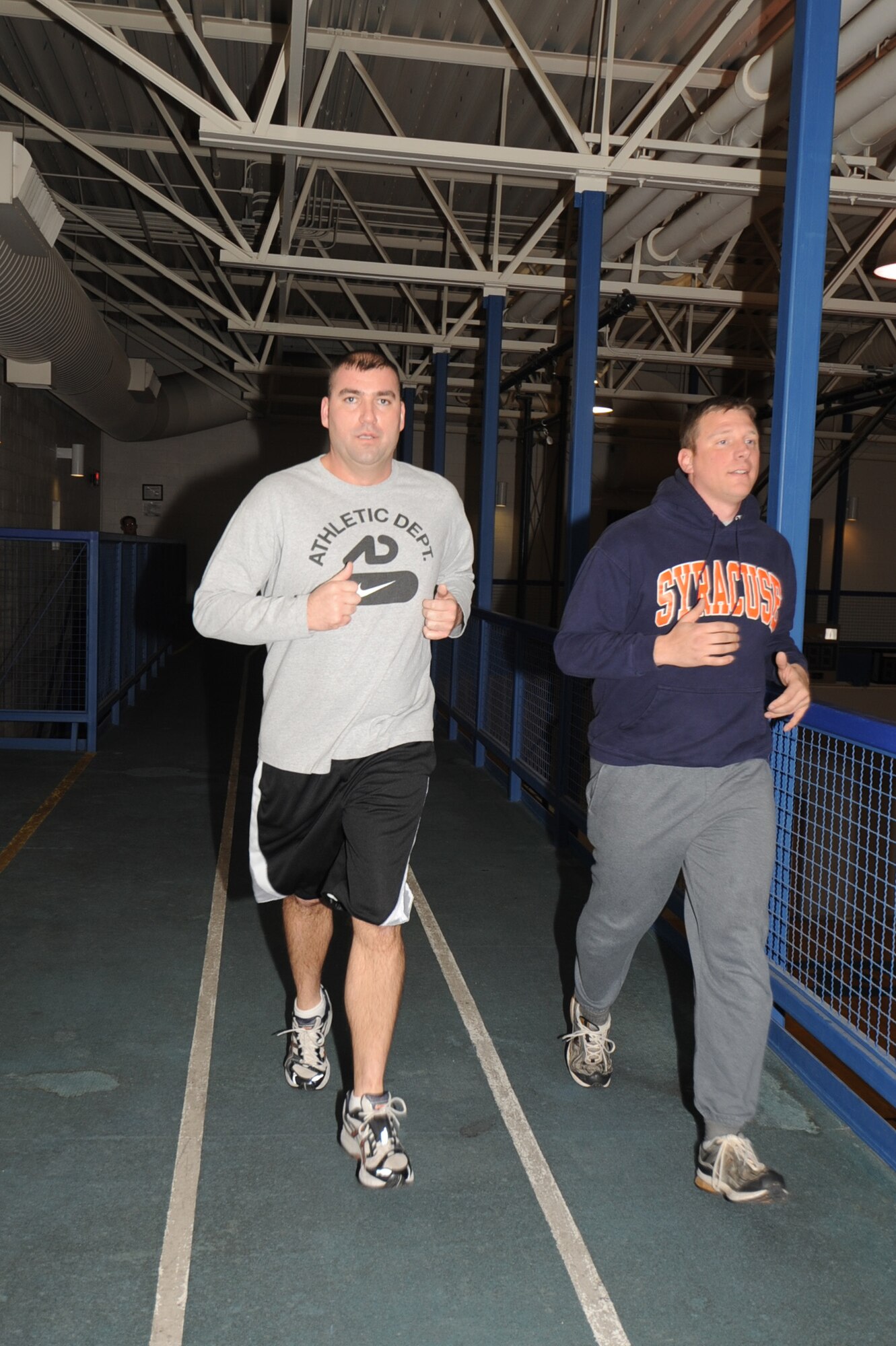 Master Sergeants John Grindstaff and Gregory Mitchell, Air Reserve Technicians with the 931st Maintenance Squadron jog at the indoor track at the Dole Center. With help from Sergeant Mitchell (left), Sergeant Grindstaff scored 92.7 points on his most recent physical fitness test. (Air Force photo by Tech. Sgt. Brannen Parrish)
