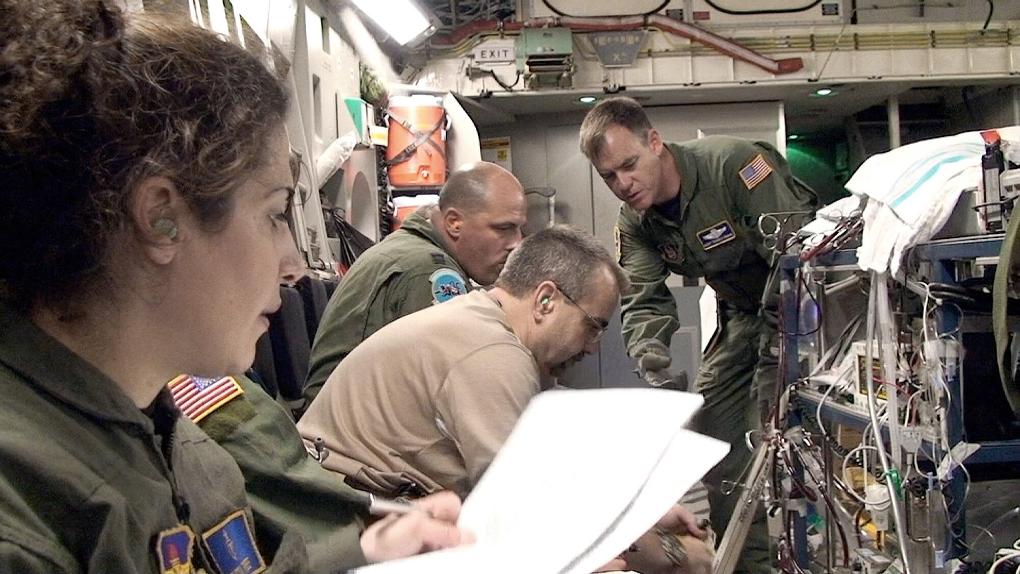 An extra corporeal membrane oxygenation team from Lackland Air Force Base, Texas, cares for a critically ill infant on-board a C-17 Globemaster III en route to California,  July 2010. The ECMO team included (left to right) then Maj. (Dr.) Melissa Tyree, from the 59th Maternal/Child Care Squadron; George Brandon, a pediatric intensive care unit nurse; Capt. Terry Bailey, a nurse from the  59th Medical Inpatient Squadron; and Master Sgt. Thomas Kamin,  from the Air Force Reserve Command 349th Aeromedical Evacuation Squadron. (U.S. Air Force photo/Maj. Kreangkai Tyree)
