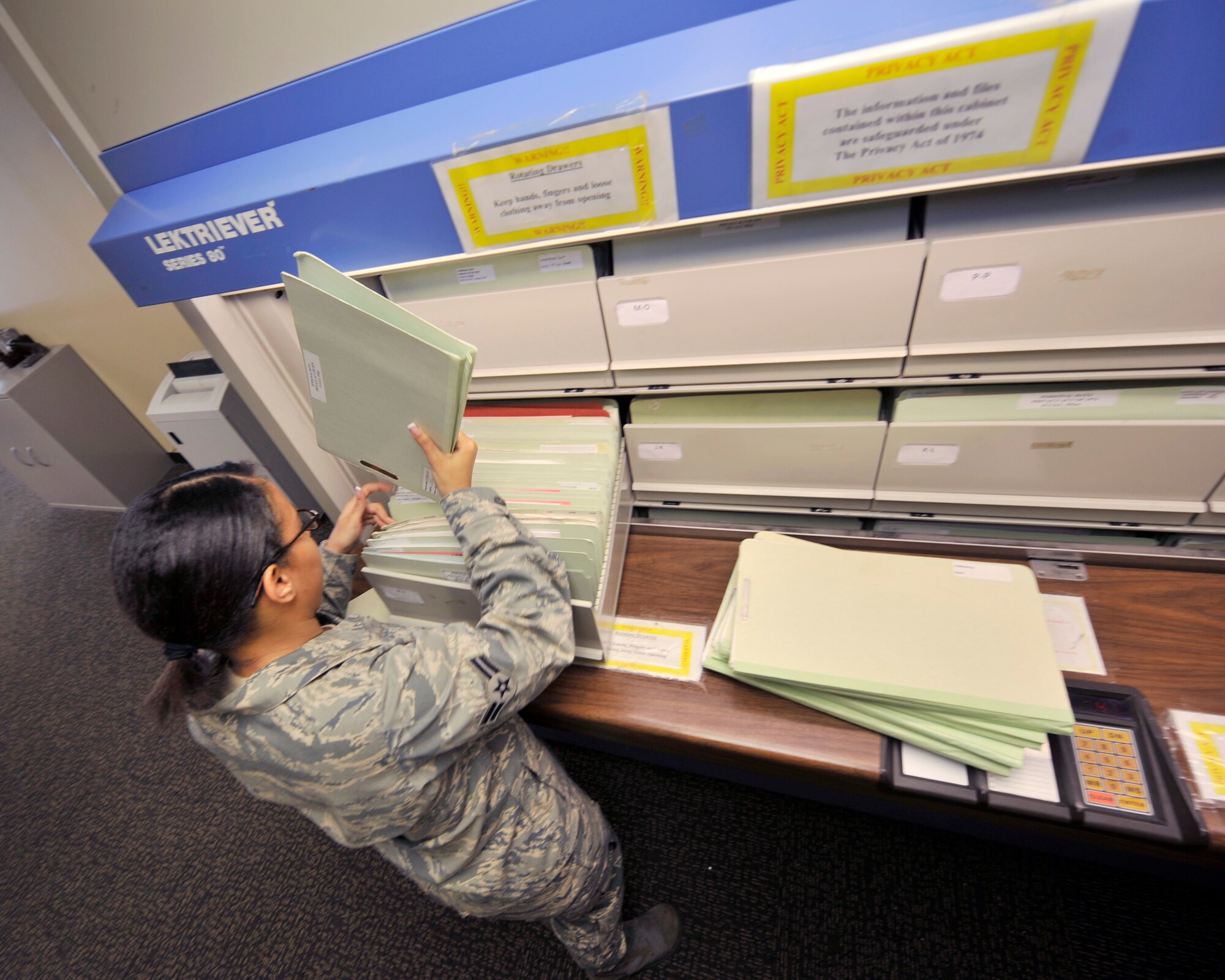 Airman 1st Class Nicole Cofey, an aviation resource manager with the 2nd Operations Support Squadron, puts aircrew members? files into the electriever filing system in the Host Aviation Resource Management office on Barksdale Air Force Base, La., Jan. 19. The electriever is an electronic filing device making it easier to keep track of the 725 aircrew records kept there. (U.S. Air Force photo/Senior Airman Chad Warren)(RELEASED)