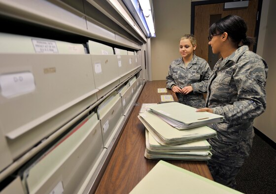 Airman 1st Class Jamie Walden (left) and Airman 1st Class Nicole Cofey, aviation resource managers with the 2nd Operations Support Squadron, sort through files of aircrew members in the Host Aviation Resource Management office on Barksdale Air Force Base, La., Jan. 19. The HARM office makes sure all aircrew are physically qualified, keeps track of all flight record folders, logs flight times, awards ratings and badges, gives flight record reviews, publishes aeronautical orders and in/out processes all flyers and jumpers on base. (U.S. Air Force photo/Senior Airman Chad Warren)(RELEASED)