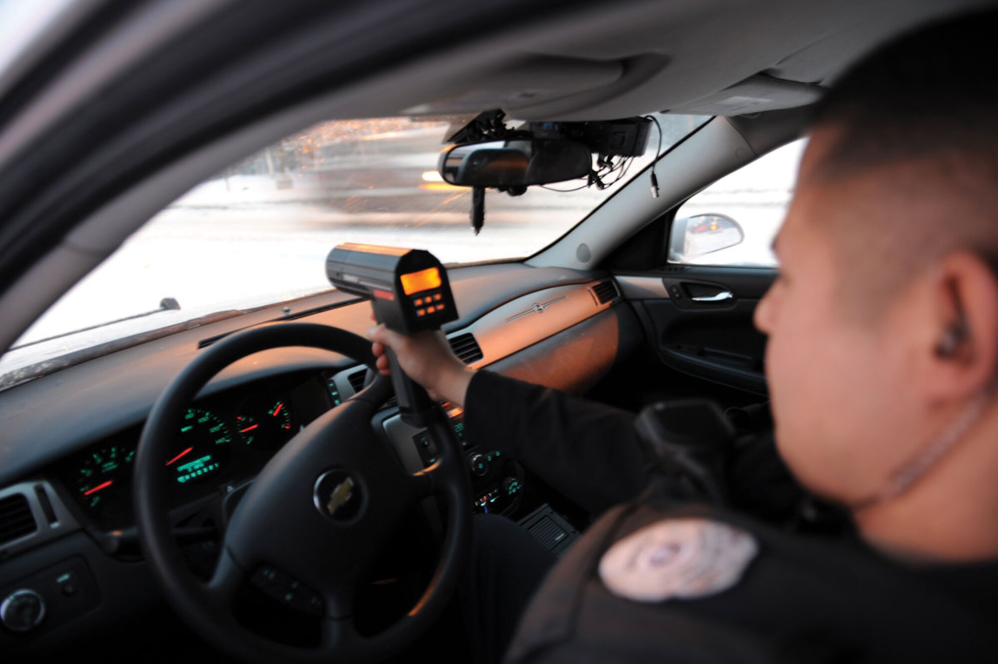 Ismael Trevino, a Joint Base Elmendorf-Richardson civilian patrol officer monitors traffic speed and looks for violations of the installation cell phone use while driving policy on Davis Highway, Thursday. (U.S. Air Force photo/Staff Sgt. Jeremy Larlee)

