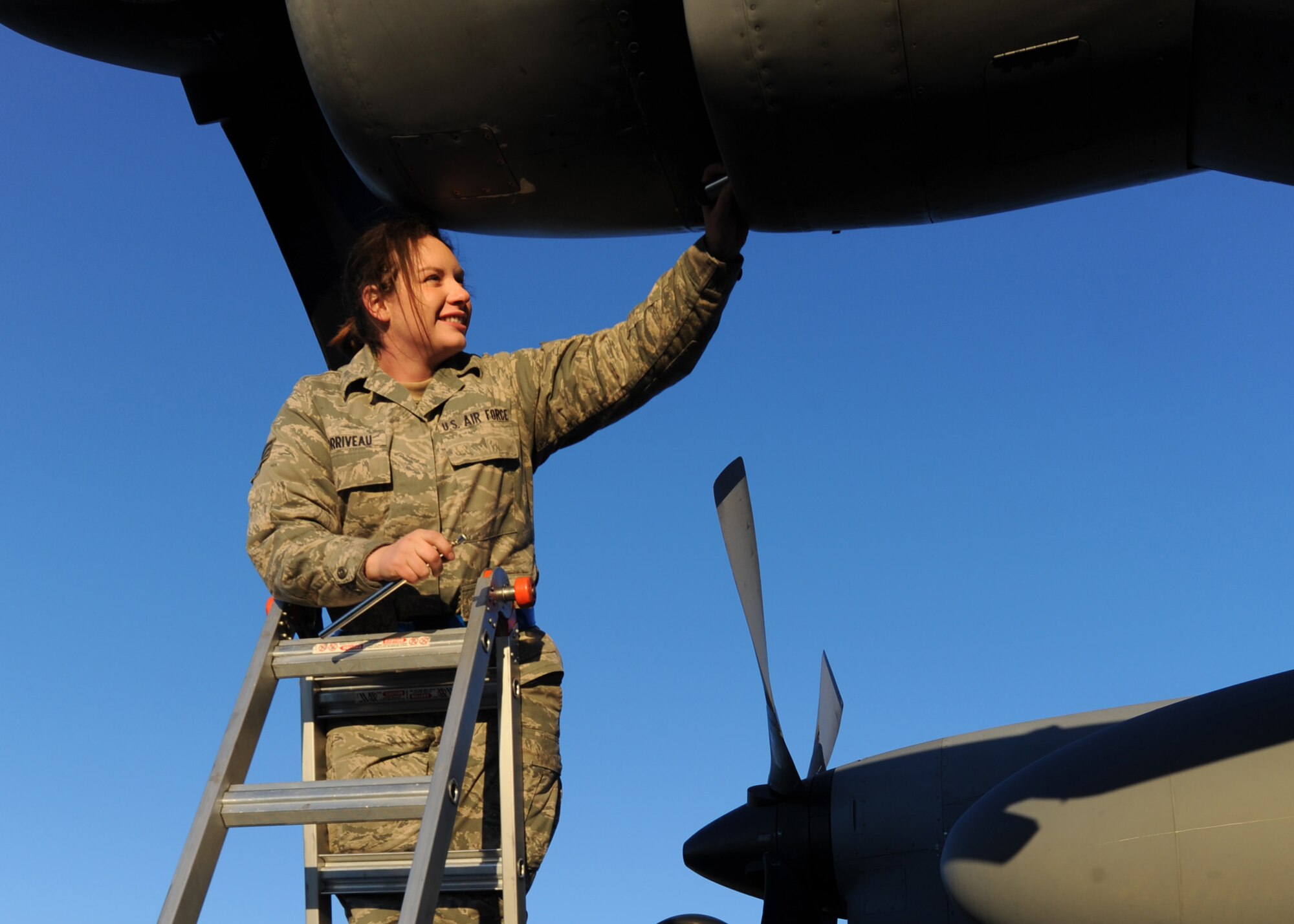 Senior Airman Jocelyn Corriveau, a crew chief with the 440th Aircraft Maintenance Squadron, inspects a C-130H aircraft engine intake for foreign objects and damage during routine maintenance at Pope Field, N.C., on Jan 21, 2011.  “[Being a mechanic] is fun,” said Airman Corriveau, “you get covered in grease, but nothing that won’t wash off.”Airman Corriveau is currently in “seasoning” training, where she receives hands-on experience in aircraft maintenance.  ( U.S. Air Force photo by Staff Sgt. Peter R. Miller)