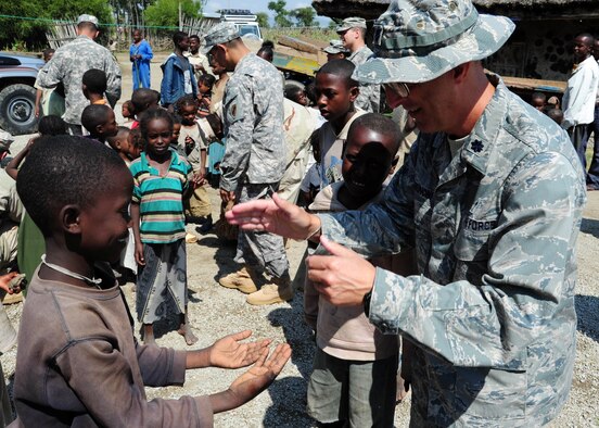 Air Force Chaplain (Lt. Col.) David Terrinoni plays a game with an Ethiopian child during a Dec. 31 visit to a local orphanage. Chaplain Terrinoni, who is currently assigned to the Combined Joint Task Force - Horn of Africa, visited the orphanage to provide a Christmas service to the orphanage and its members. Chaplain Terrinoni is the 72nd Air Base Wing chaplain. (Air Force photo by Airman 1st Class Jevon Smith)