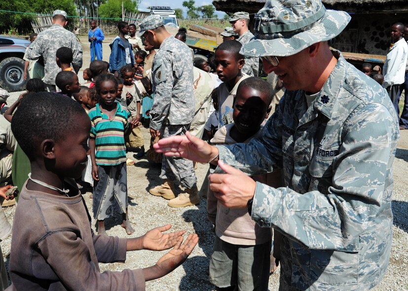 Air Force Chaplain (Lt. Col.) David Terrinoni plays a game with an Ethiopian child during a Dec. 31 visit to a local orphanage. Chaplain Terrinoni, who is currently assigned to the Combined Joint Task Force - Horn of Africa, visited the orphanage to provide a Christmas service to the orphanage and its members. Chaplain Terrinoni is the 72nd Air Base Wing chaplain. (Air Force photo by Airman 1st Class Jevon Smith)