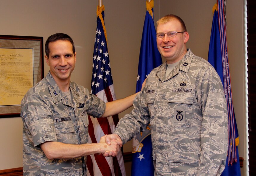 Captain Randall P. Gernhardt, 911th Security Forces Squadron operations officer, is congratulated by Col. Jeffrey Pennington, 911th Airlift Wing Commander, for being recognized as the Air Force Reserve Command’s 2010 Outstanding Security Forces Company Grade Officer, Jan. 8. (U.S. Air Force photo/Senior Airman Jonathan Hehnly)