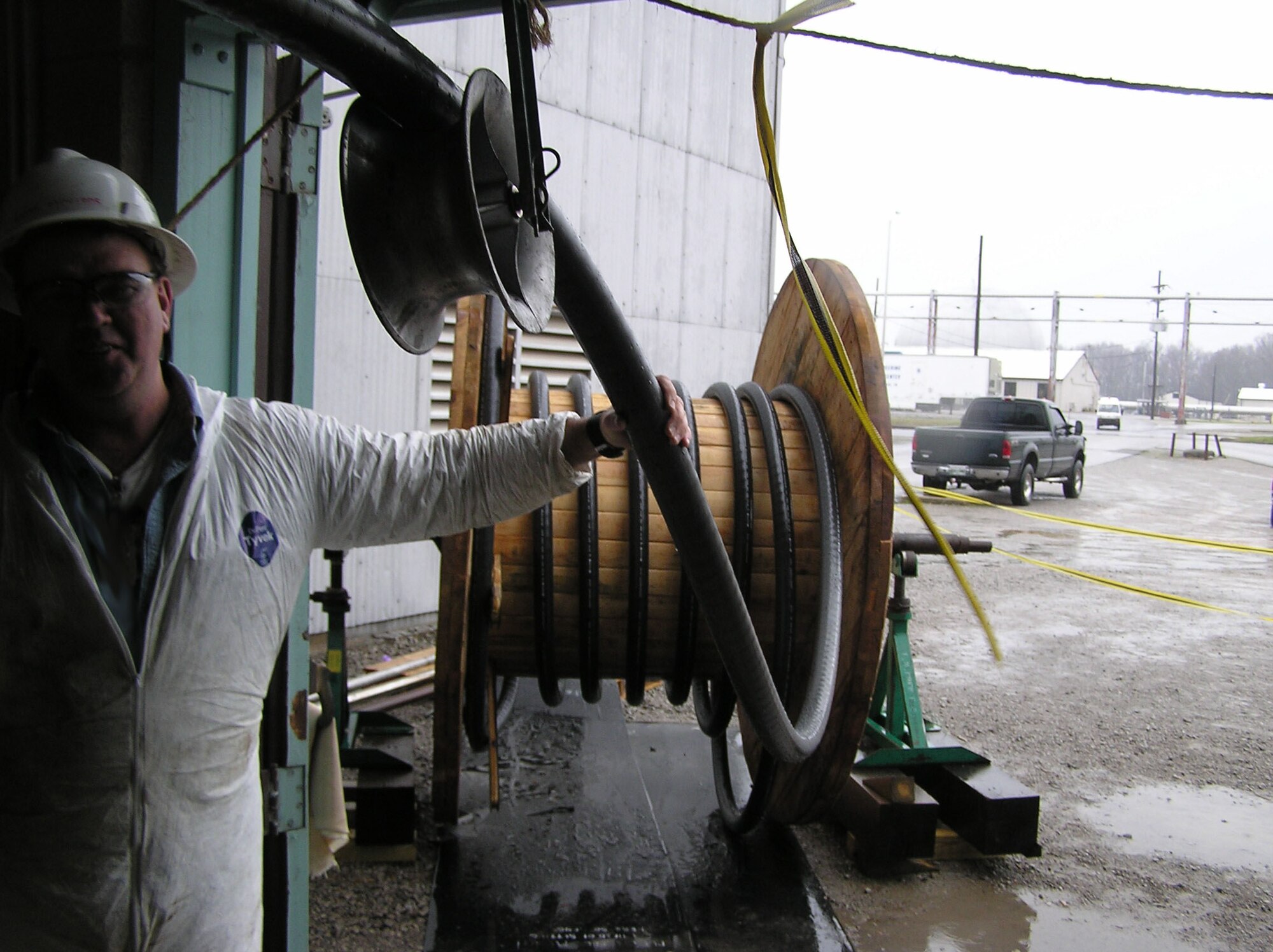 Wayne Richards, lead electrician for the high voltage cable installation, is shown in April 2008 running the 3,000 feet of 3,500 KCM cable used to replace the aging 1,500 KCM cable in the A/B Exhaust Plants upgrade. (Photo provided by Tony Medley)
