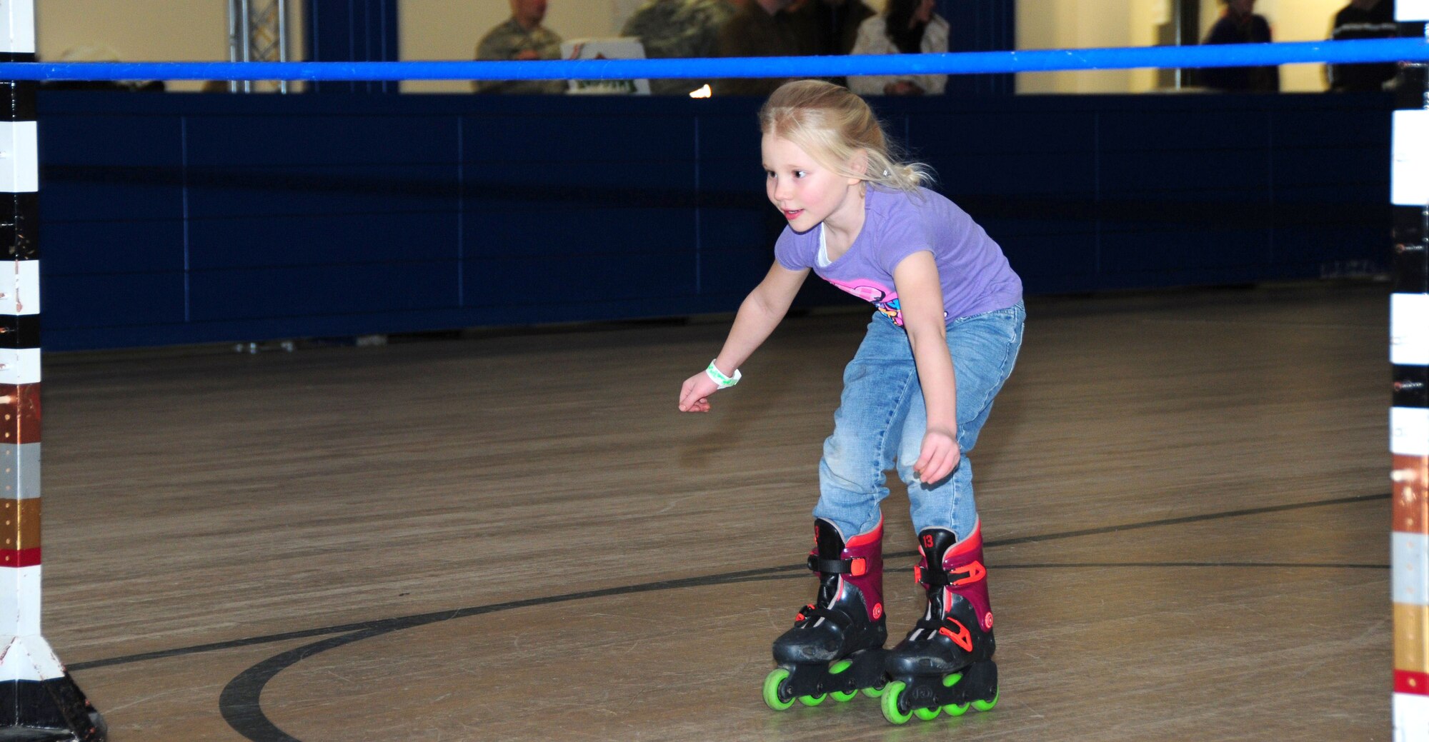 ROYAL AIR FORCE LAKENHEATH, England -- Juliana Berry, age 6, daughter of Master Sgt. Jason Berry, 48th Civil Engineer Squadron fire department, and Leisha Berry participates in a limbo contest at the skating rink during the Deployed Family Member Social, Jan. 19. Each social is sponsored by different organizations on base. The Community Action Information Board and Integrated Delivery System co-sponsored for this quarter. The social is held each quarter for families with deployed members and is hosted by the Airmen and Family Readiness Center. (U.S. Air Force photo/Staff Sergeant Connor Estes)
