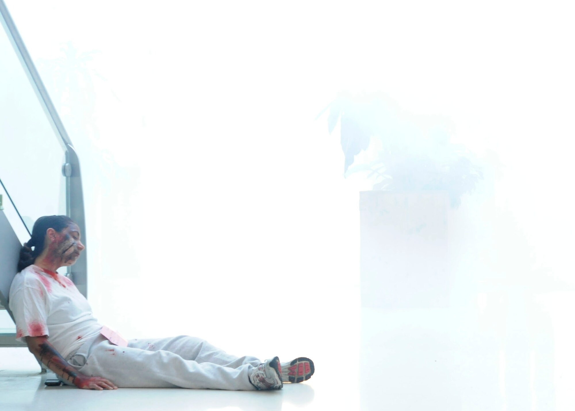 ROYAL AIR FORCE LAKENHEATH, England - 2nd Lt. Celeste Luna, 492nd Fighter Squadron director of intelligence, poses as a victim of an active shooter demonstration at the Lakenheath Sports & Fitness Center on Jan. 21. The exercise included smoke filling the center, guns firing blanks, alarms going off and other aspects to make the exercise as realistic as possible. (U.S. Air Force photo/Senior Airman Tiffany M. Deuel)