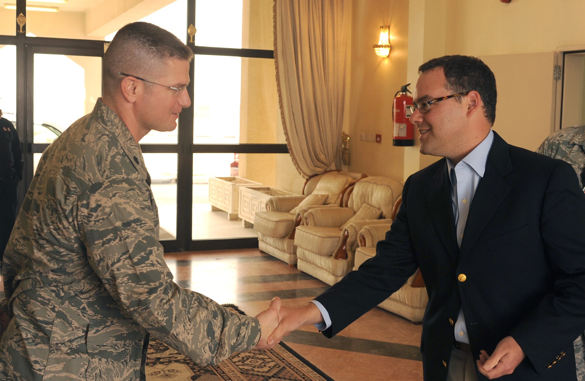 Mr. Daniel B. Ginsberg, Assistant Secretary of the Air Force for Manpower and Reserve Affairs, thanks Lt. Col. Nathan Chine, 379th Expeditionary Force Support Squadron commander for his assistance during his visit to Southwest Asia, Jan. 21. Mr. Ginsberg was given a tour of the base to see the different facilities offered to deployed Airmen.  (U.S. Air Force photo/Staff Sergeant Liliana Moreno) (RELEASED)        