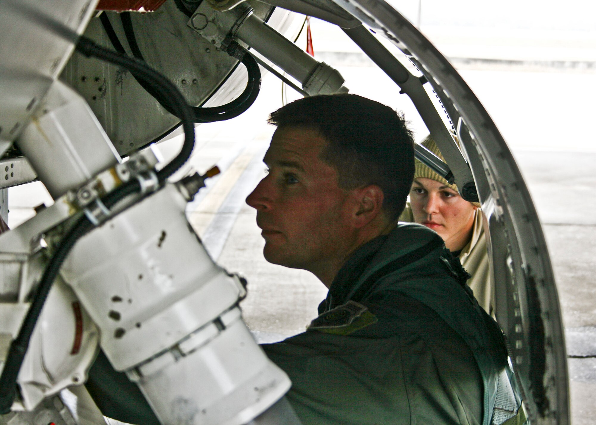 Lt. Col. John Wilbourne, 58th Fighter Squadron commander, and Airman 1st Class Christopher Pizzitola, 56th Aircraft Maintenance Squadron crew chief, look over their F-16 prior to flying the 33rd Fighter Wing’s first sortie at Eglin Air Force Base, Fla., Jan. 18.  The mission was a long-time coming for the former F-15 wing that transitioned to the DoD’s first F-35 training wing in October 2009.  (U.S. Air Force photo/2nd Lt. Andrew Caulk) 