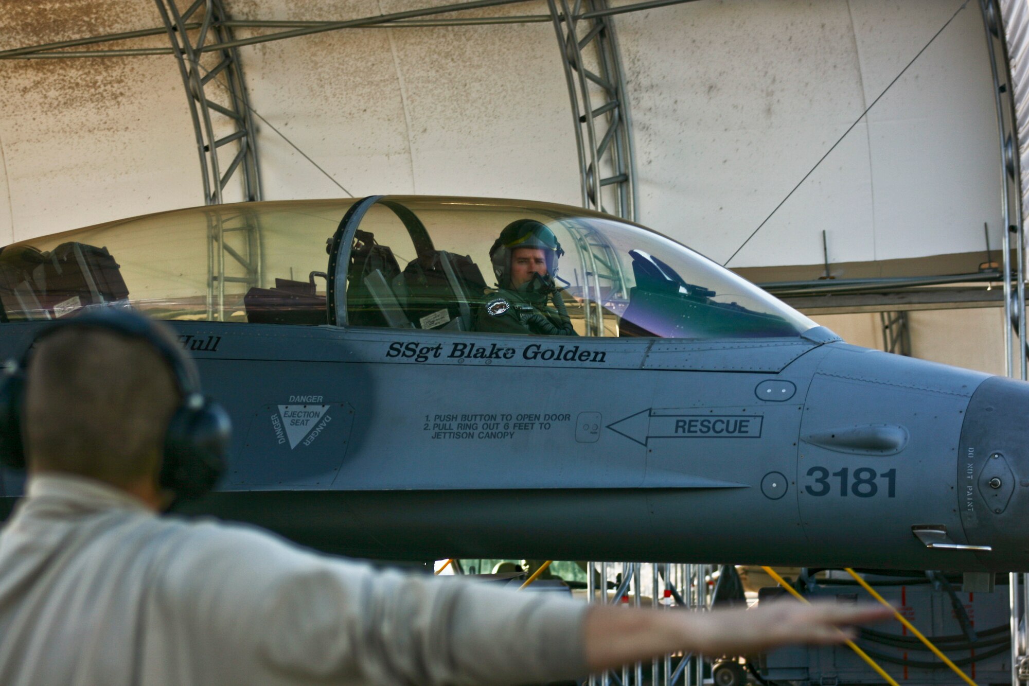 Airman 1st Class Christopher Pizzitola, 56th Aircraft Maintenance Squadron crew chief, marshals Lt. Col. John Wilbourne, 58th Fighter Squadron commander, and his F-16 out at Eglin Air Force Base, Fla., Jan. 18.  Colonel Wilbourne and Maj. Matthew Renbarger, 58th FS deputy of operations, flew the first sortie for the 33rd Fighter Wing since it switched to its new training mission designation.  The mission was a long-time coming for the former F-15 wing that transitioned to the DoD’s first F-35 training wing in October 2009.  (U.S. Air Force photo/2nd Lt. Andrew Caulk)