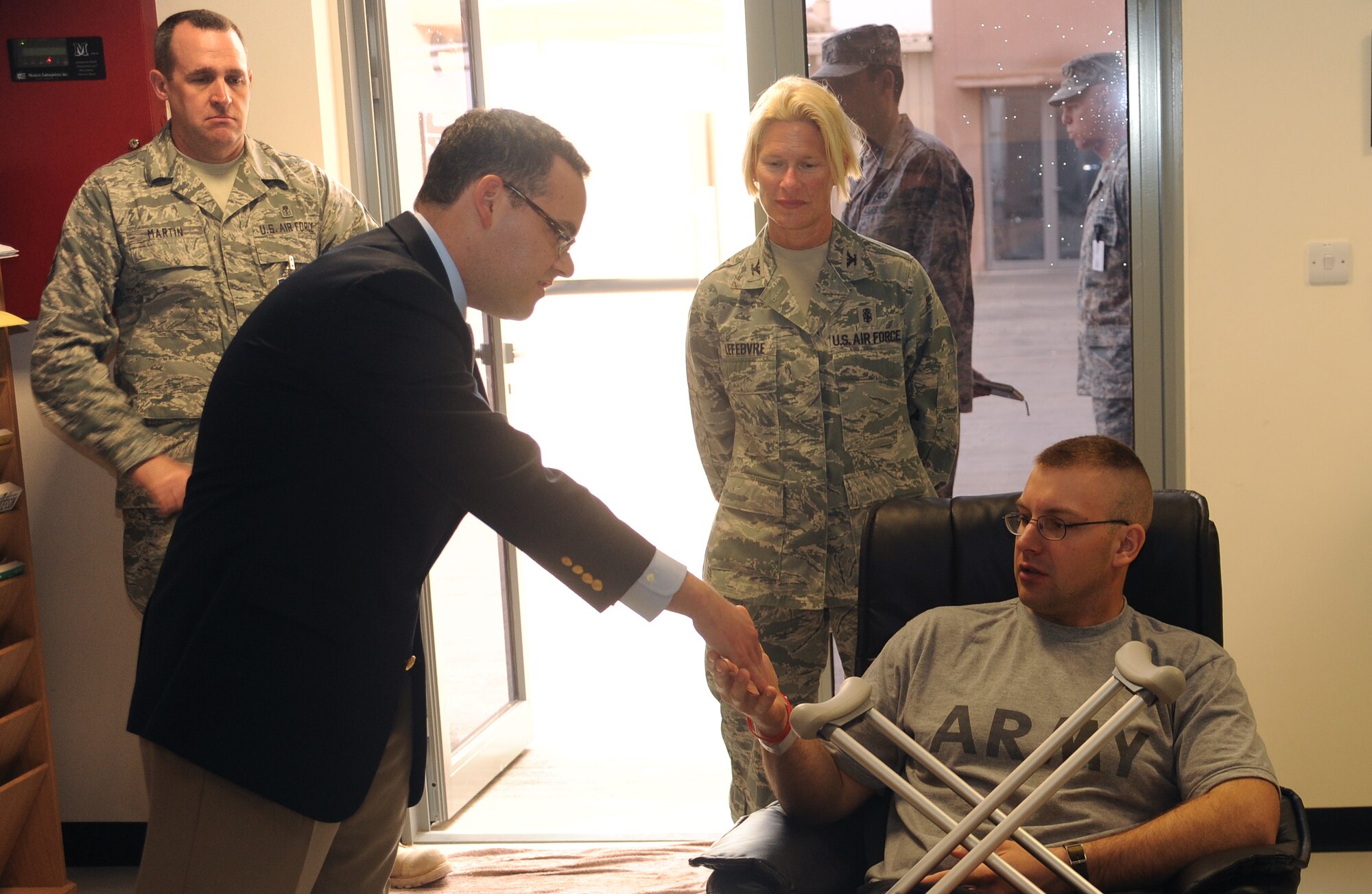 Mr. Daniel B. Ginsberg, Assistant Secretary of the Air Force for Manpower and Reserve Affairs, coins an Army soldier while taking a tour of the 379th Expeditionary Medical Group in Southwest Asia, Jan. 21  (U.S. Air Force photo/Staff Sergeant Liliana Moreno) (RELEASED)                                        