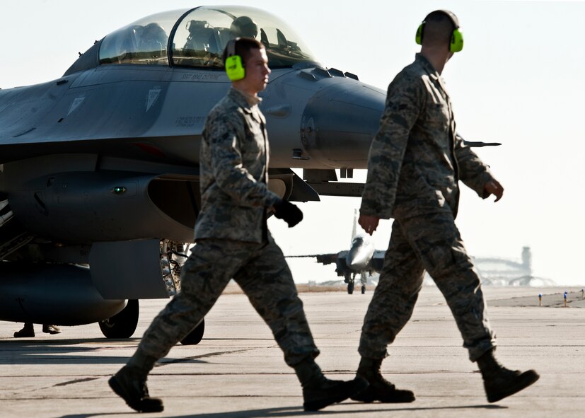 F-15E maintainers from the 46th Maintenance Group move into place as their aircraft taxis toward them for a final check before takeoff from Eglin Air Force Base Fla., Jan. 18.  The Strike Eagle flew the first ever sortie with the new APG-82 radar.  The new radar replaces the 24-year-old APG-70 radar system.  (U.S. Air Force photo/Samuel King Jr.)