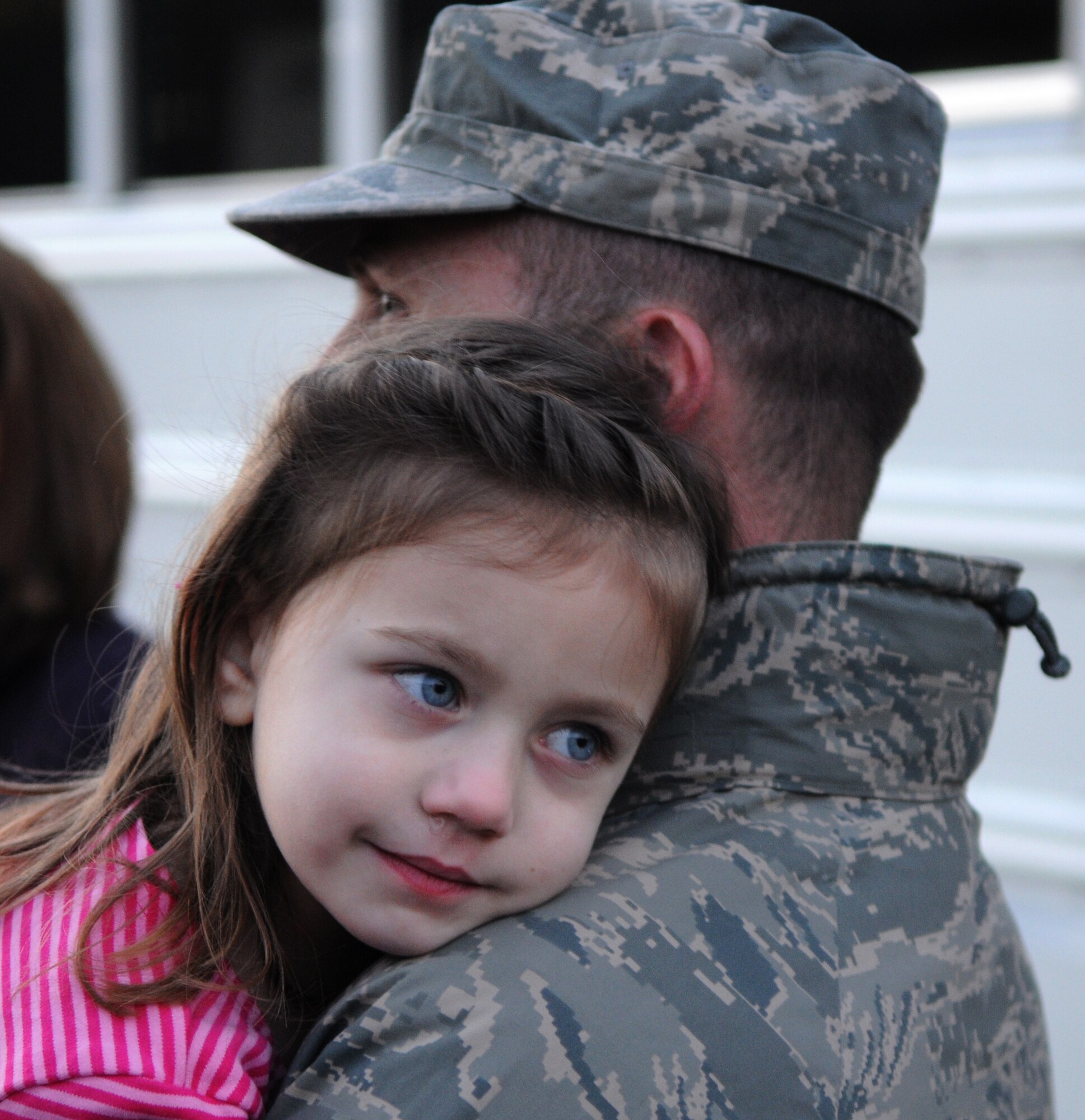 SPANGDAHLEM AIR BASE, Germany – Major John McCann, 606th Air Control Squadron chief of maintenance, hugs his daughter Ella after returning home from deployment Jan. 21. Airmen from the 606th ACS returned from bases in Southwest Asia and Kandahar Airfield, Afghanistan. Family members and fellow servicemembers waited to greet the Airmen upon their return here after 6- and 7-month deployments. (U.S. Air Force photo/Airman 1st Class Matthew B. Fredericks)