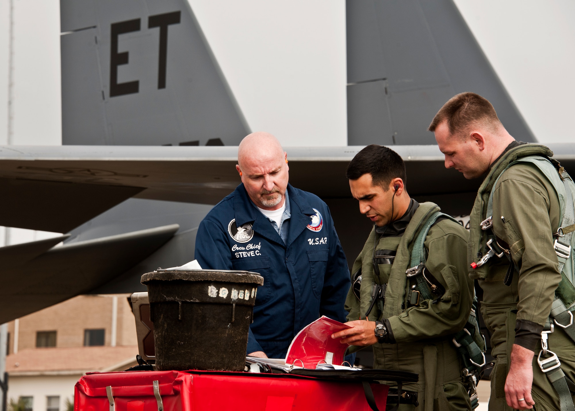 Steve Coleman, crew chief, reviews the F-15E logbook with Maj. Raja Chari, pilot, and Capt Chris Dupin, 40th Flight Test Squadron weapons system officer, prior to their sortie from Eglin Air Force Base, Fla., Jan. 18.  The Strike Eagle flew the first ever sortie with the new APG-82 radar.  The new radar replaces the 24-year-old APG-70 radar system.  (U.S. Air Force photo/Samuel King Jr.)