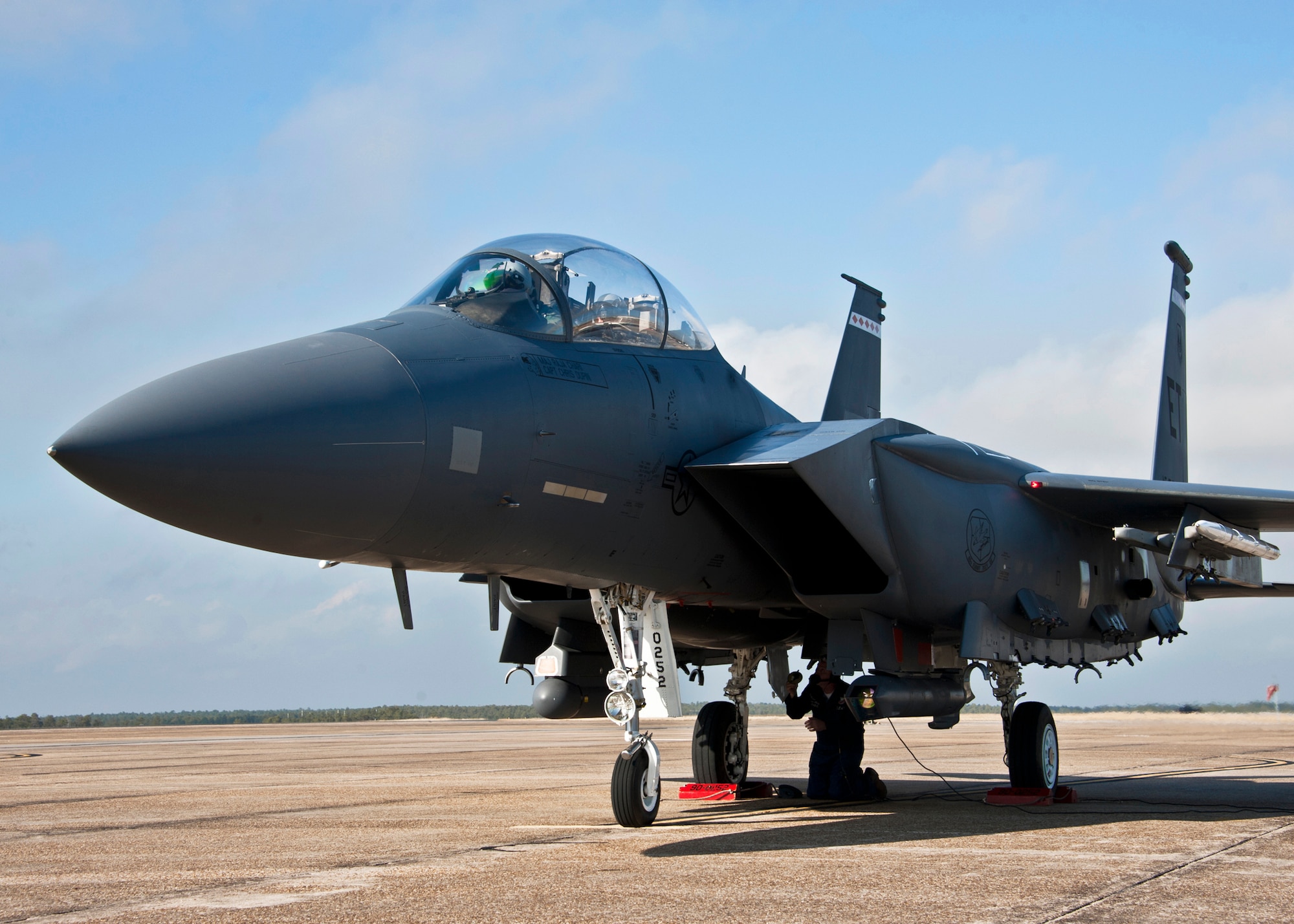 Steve Coleman, F-15E crew chief, completes last minute checks underneath the plane prior to it taxiing out from Eglin Air Force Base’s flightline, Jan. 18.  The Strike Eagle flew the first ever sortie with the new APG-82 radar.  The new radar replaces the 24-year-old APG-70 radar system.  (U.S. Air Force photo/Samuel King Jr.)