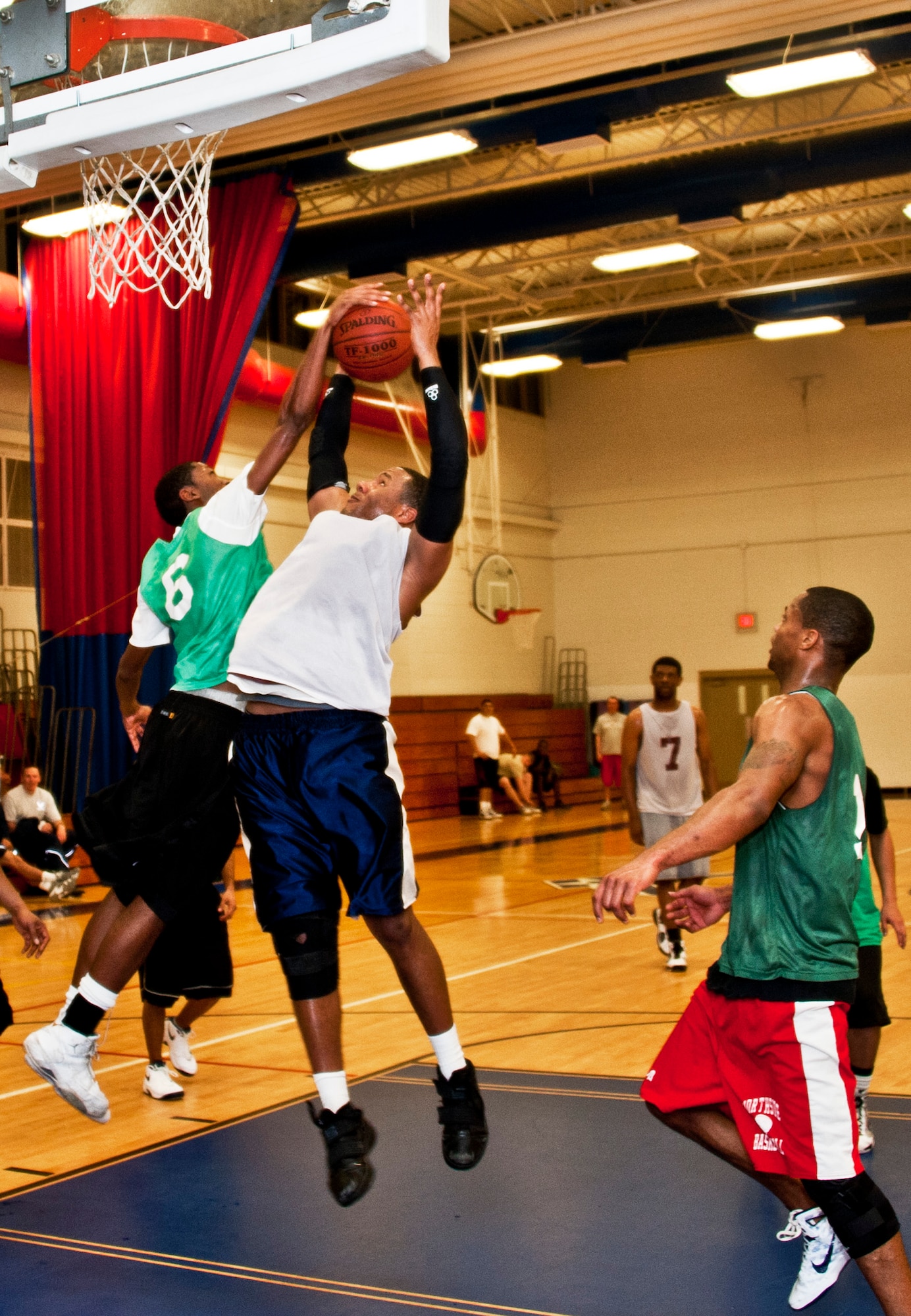 Andre Hammond, 96th Medical Group, blocks a shot by a 96th Logistics Readiness Squadron player during the intramural championship game Jan. 19 at Eglin Air Force Base, Fla.  LRS defeated MDG, last year’s champs, 64-56 in a double-overtime thriller. (U.S. Air Force photo/Samuel King Jr.)