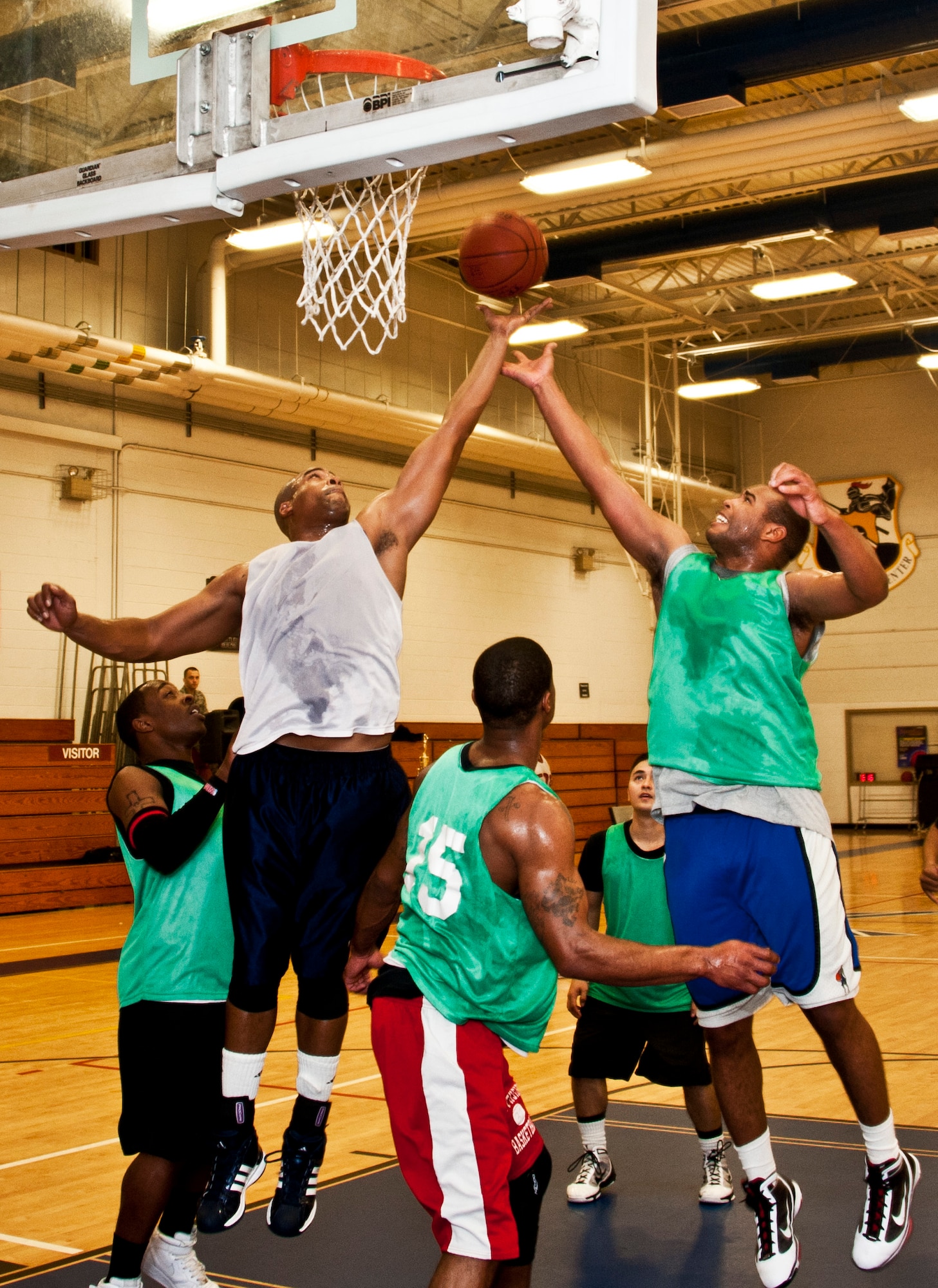 Anthoine Corpening, 96th Logistics Readiness Squadron, gets up for an offensive rebound against a 96th Medical Group defender during the intramural championship game Jan. 19 at Eglin Air Force Base, Fla.  LRS defeated MDG, last year’s champs, 64-56 in a double-overtime thriller.  Corpening, LRS team captain, carried his team to victory scoring 30 points.  (U.S. Air Force photo/Samuel King Jr.)