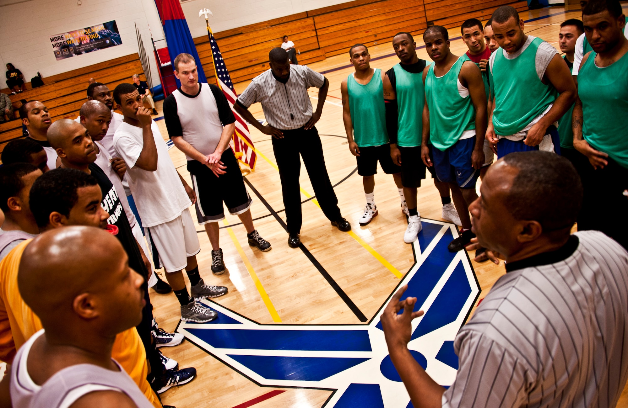 The referee explains the rules to both the 96th Logistics Readiness Squadron (left) and the 96th Medical Group prior to the game, Jan. 19 at Eglin Air Force Base, Fla.  LRS unseated last year’s champs in a double-overtime thriller, 64-56.  (U.S. Air Force photo/Samuel King Jr.)