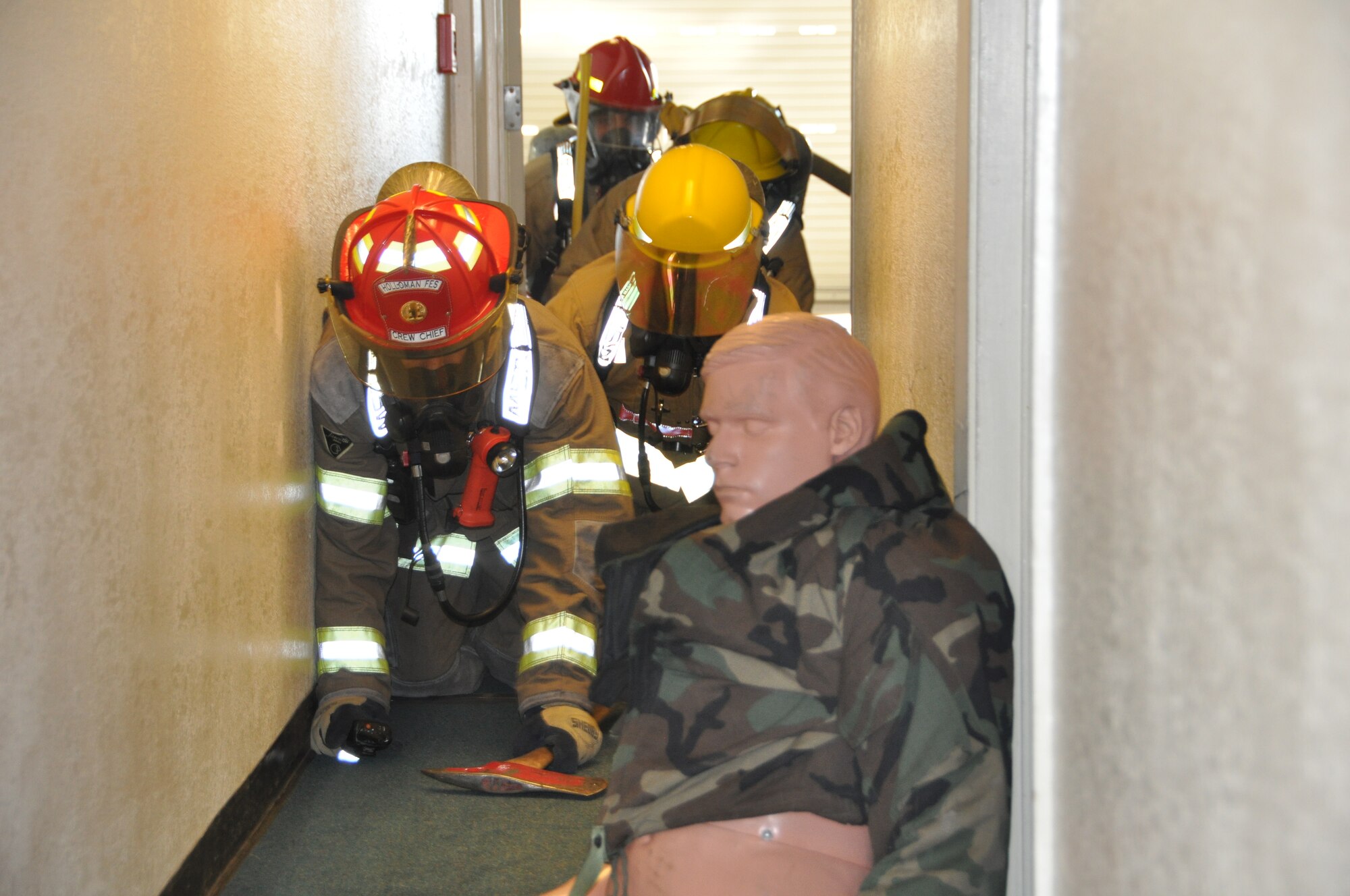 Firefighters from the Fire Emergency Service Squadron practice saving a victim, a 175 pound dummy, during a structure fire practice exercise. ( U.S. Air Force photo/ 2nd Lt. Katie Batchelder)