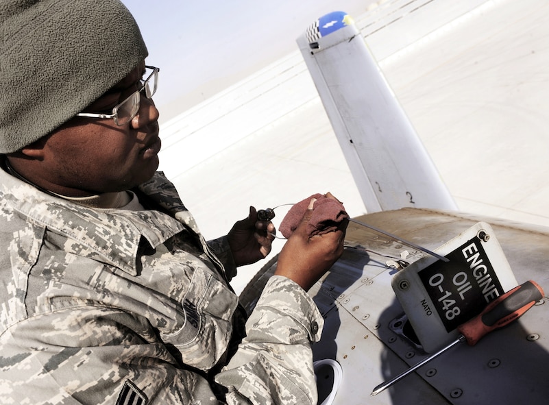 Senior Airman Christopher Smith checks the engine oil for an A-10C Thunderbolt II, Jan. 11, 2011, at Kandahar Airfield, Afghanistan. Airman Smith is a crew chief assigned to the 451st Expeditionary Aircraft Maintenance Squadron. (U.S. Air Force photo/Senior Airman Willard E. Grande II)