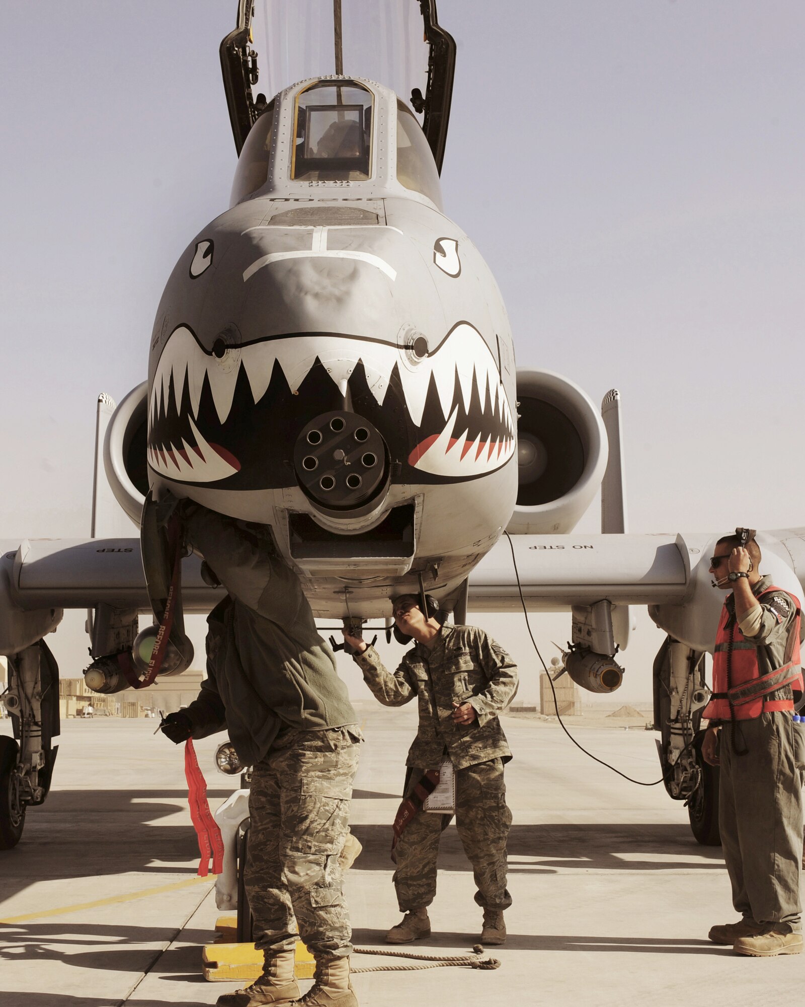 Crew chiefs install pins on an A-10C Thunderbolt II, Jan. 11, 2011, at Kandahar Airfield, Afghanistan. The 75th Expeditionary Fighter Squadron recently moved their assets to the other side of the flightline, marking the first of many moves toward consolidating the wing's missions. The crew chiefs are assigned to the 451st Expeditionary Aircraft Maintenance Squadron. (U.S. Air Force photo/Senior Airman Willard E. Grande II)
