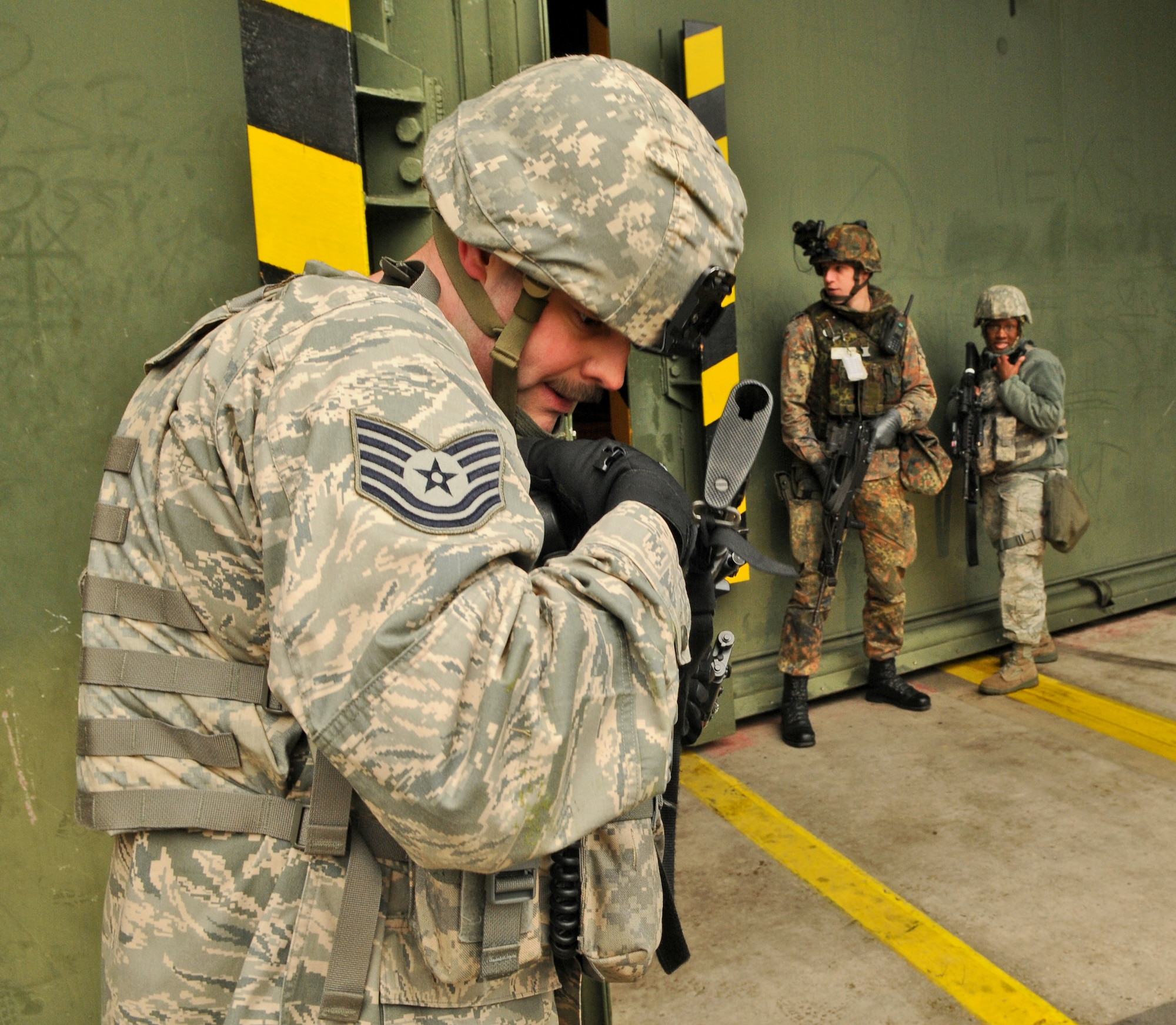 SPANGDAHLEM AIR BASE, Germany – Tech. Sgt.  Christian Stidham, 702nd Munitions Support Squadron custody forces flight chief, communicates via radio with members on his flight during a joint force recapture and recovery exercise Jan. 18. The exercise simulated a combat area of responsibility and tested German air force members’ ability to perform and operate in a real-world war zone. (U.S. Air Force photo/Senior Airman Nick Wilson)