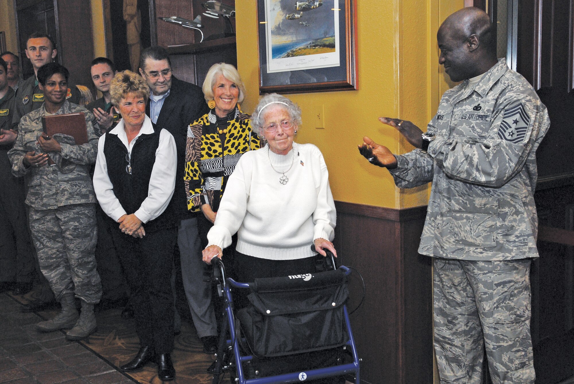 The family of Chief Master Sgt. Donald Harlow, the second Chief Master Sgt. of the Air Force, receieves applause from Luke Airmen on January 14th during the enlisted heritage room naming ceremony at Club Five Six.  The room was named in honor of the late CMSAF.  (U.S. Air Force photo/Senior Airman Tracie Forte)