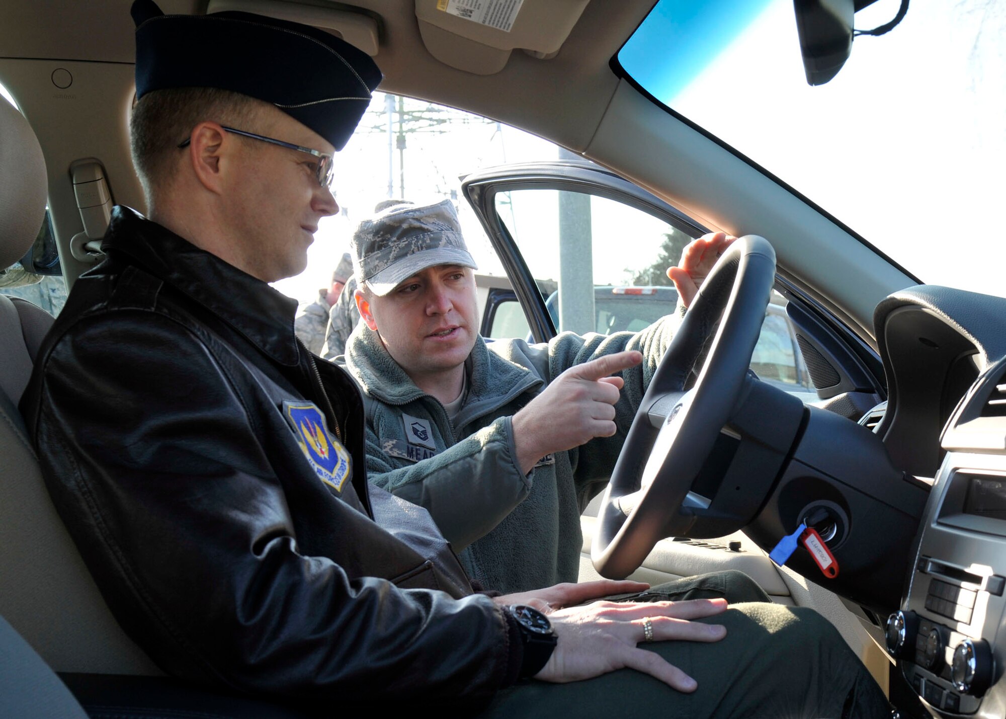 SPANGDAHLEM AIR BASE, Germany— Master Sgt. Kevin Mead, European Transportation Training Center Instructor, instructs Col. Christopher Weggeman, 52nd Fighter Wing commander, on the proper use of his new 2010 Ford Fusion Hybrid here Jan. 21. Colonel Weggeman is the first person to drive a hybrid in the fleet at Spangdahlem as a step toward the goal to comply with an Executive Order requiring a 34 percent reduction in greenhouse gas emissions by 2020 and 20 percent reduction of petroleum use by 2015. (U.S. Air Force photo/ Airman 1st Class Brittney Frees)