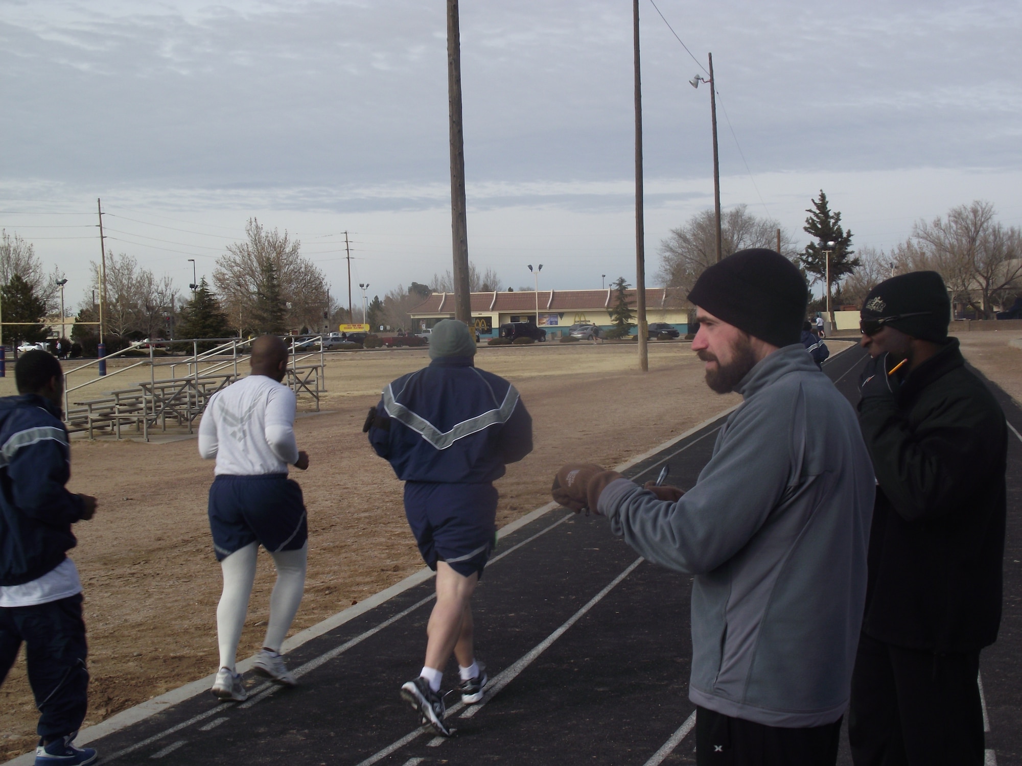 Zac Holmes, left, and Taj Kyle, of the Fitness Assessment Cell, administer a physical training test Jan. 11 to Airmen at Kirtland Air Force Base.  U.S. Air Force Photo by Jasmine Simon.