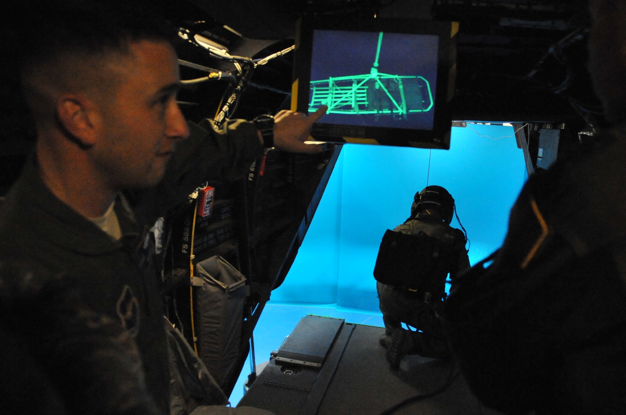 Master Sgt. Nicholas Pelhan, 58th Training Squadron, left, explains a new simulation device for rescue to Maj. Gen. Mark Solo, 19th Air Force commander.  U.S. Air Force Photo by Elizabeth Martinez.