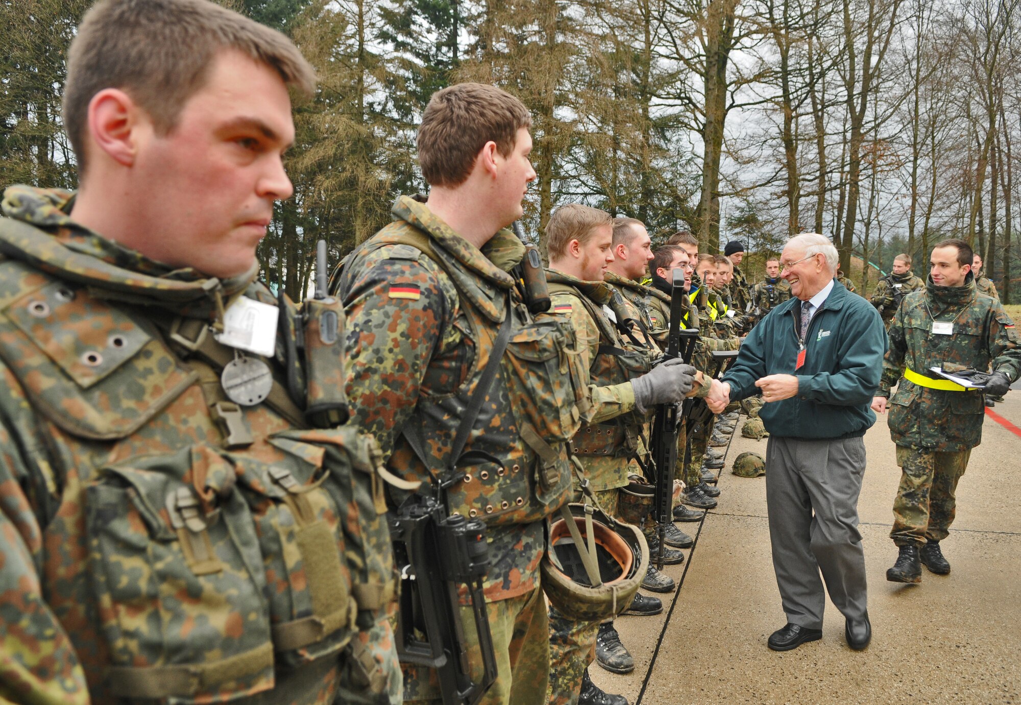 SPANGDAHLEM AIR BASE, Germany – Members of the German air force wait in line to meet retired Chief Master Sgt. of the Air Force Sam Parish after they finished an exercise in front of a hardened aircraft shelter at Beuchel  Air Base, Germany, Jan. 18. Chief Parish visited Beuchel AB, the 52nd Fighter Wing and some of its geographically-separated units to speak about developing and mentoring young Airmen and turning them into the leaders of tomorrow. (U.S. Air Force photo/Senior Airman Nick Wilson)