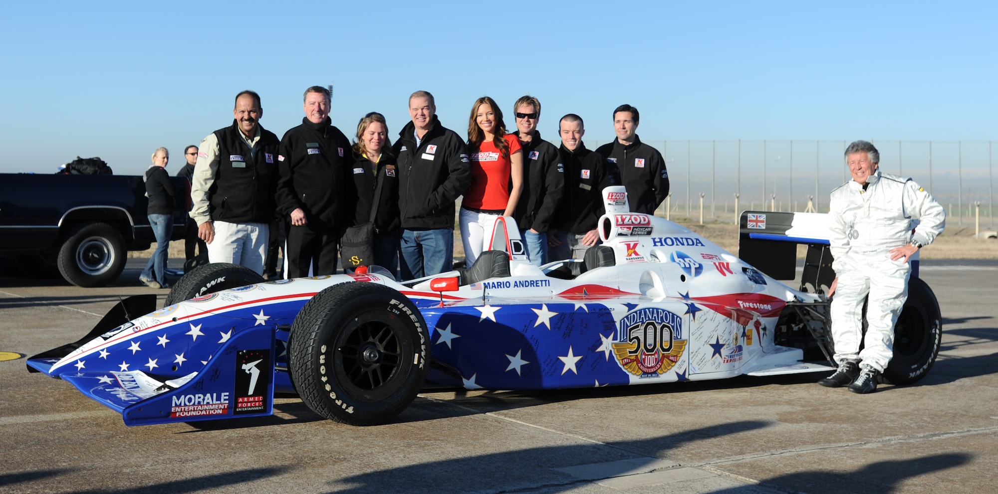 Members of the Indianapolis 500 Centennial Tour pose next to the Tour racecar before demonstration rides, Jan. 19, 2011, at Incirlik Air Base, Turkey. Base personnel were allowed to register for a chance to win a demo ride with four-time Indy 500 race winner, Mario Andretti.  (U.S. Air Force photo/Airman 1st Class Clayton Lenhardt/Released)