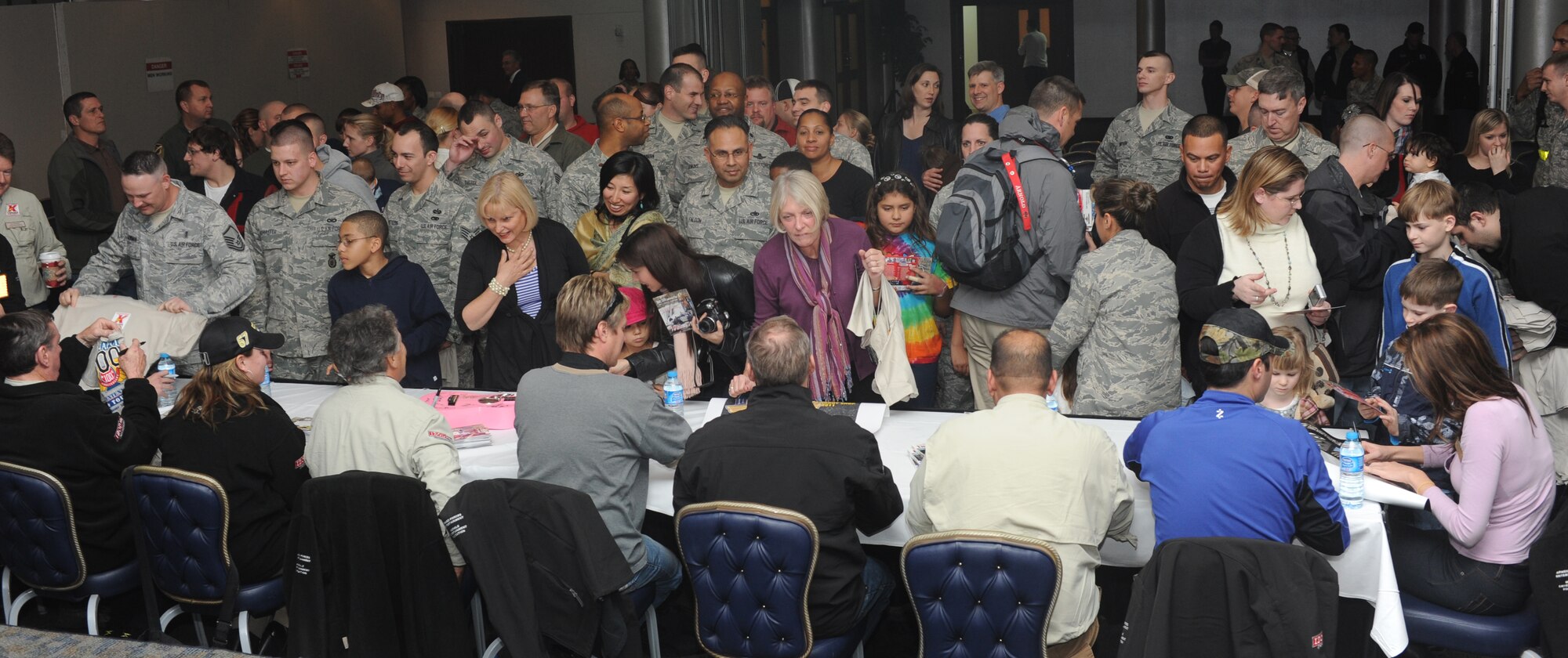 Members of the Indy 500 Centennial Tour sign autographs for Airmen and their families while visiting Incirlik Air Base, Turkey, Jan. 18, 2011. The Indy 500 Centennial Tour, coordinated by Morale Entertainment Foundation and Armed Forces Entertainment, in conjunction with the IZOD IndyCar Series and the Indianapolis Motor Speedway, is a 10-day goodwill trip to Europe and the Middle East with the goal of boosting the morale of more than 10,000 servicemembers. (U.S. Air Force photo/Airman 1st Class Clayton Lenhardt/Released)