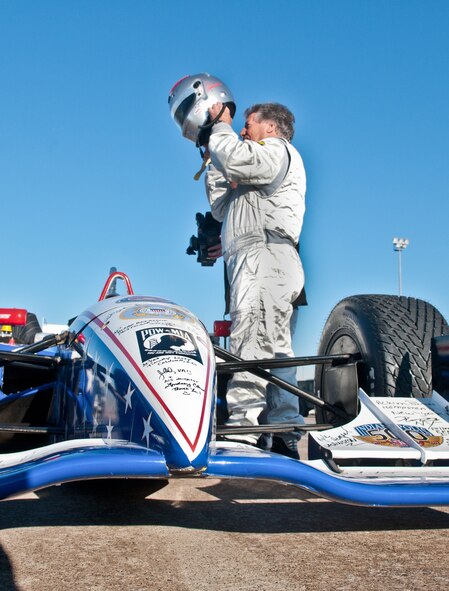 Four-time Indianapolis 500 race winner Mario Andretti , prepares to give a demonstration ride to Airmen during the Indy 500 Centennial Tour Jan. 19, at Incirlik Air Base, Turkey. More than 30 individuals were chosen to ride in the Indy 500 racecar. The Indy 500 Centennial Tour, coordinated by Morale Entertainment Foundation and Armed Forces Entertainment, in conjunction with the IZOD Indy Car Series and the Indianapolis Motor Speedway, is a 10-day morale trip to Europe and the Middle East with the goal of boosting the morale of more than 10,000 servicemembers. The team, which includes Indianapolis 500 winners Mario Andretti, Johnny Rutherford and Al Unser Jr. plus Indy 500 veterans Sarah Fisher, Davey Hamilton, Larry Foyt and Firestone Indy Lights race winner Martin Plowman, spoke with the winners and signed autographs during the visit. (U.S. Air Force photo by Staff Sergeant Alexandre Montes/Released)
