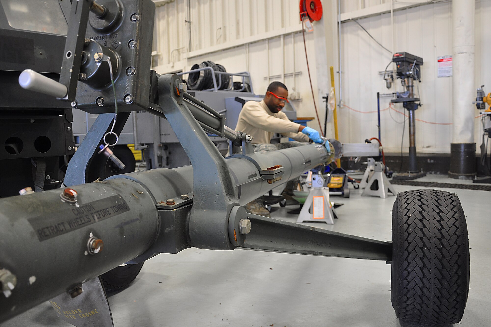 JOINT BASE MCGUIRE-DIX-LAKEHURST, N.J. -- Senior Airman Michael O'Neil, an aerospace ground equipment technician with 514th Maintenance Squadron, repairs a flange on a universal aircraft tow bar here Jan. 20, 2011. The damaged flange was discovered during a scheduled maintenance inspection. The scheduled inspections help to identify and correct potential maintenance problems to ensure the equipment properly operates when used for aircraft maintenance. (U.S. Air Force photo/Tech. Sgt. Shawn J. Jones)