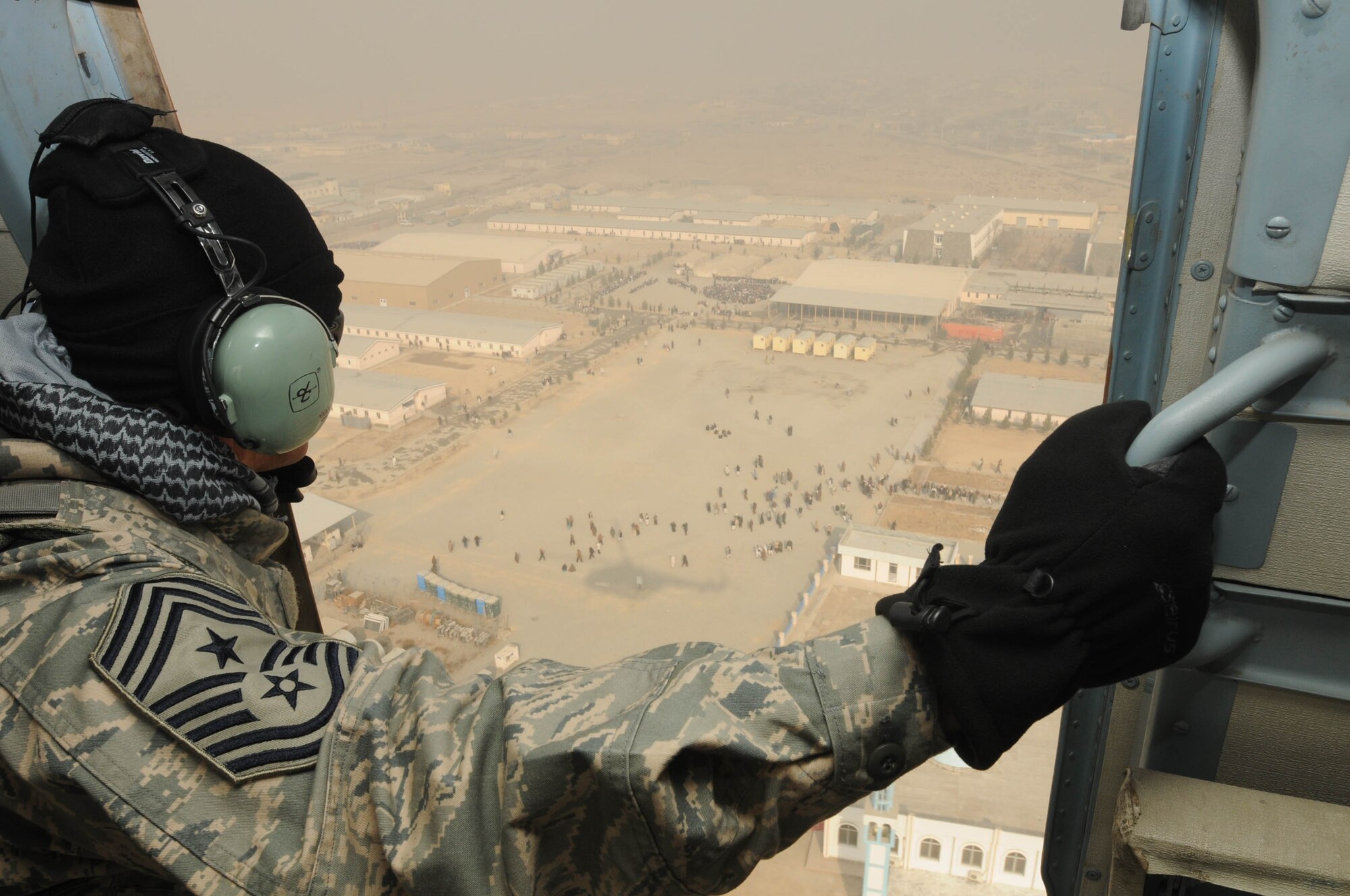 KABUL, Afghanistan - Command Chief Master Sgt. Richard Parsons, U.S. Air Forces Central, flies over Kabul in a Mi-17 helicopter, during his tour of NATO Air Training-Afghanistan/438th Air Expeditionary installations at the Afghan Air Force base in Kabul, Afghanistan, Jan. 19, 2011. During his visit, Chief Parsons met with Airmen from the 438th Air Expeditionary Wing to get to know them an their mission. (U.S. Navy photo by Mass Communications Specialist 3rd Class Petty Officer Jared E. Walker/ RELEASED).