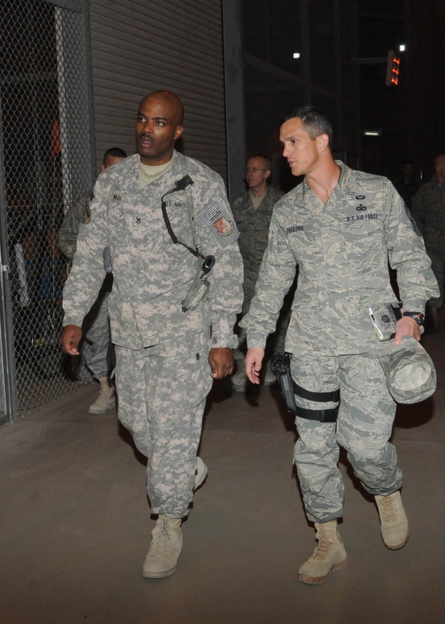 KABUL, Afghanistan - Command Chief Master Sgt. Richard Parsons, U.S. Air Forces Central, speaks to Aviation Mechanic 1st Class Petty Officer (AW) Randy Wade, during his tour of NATO Air Training-Afghanistan/438th Air Expeditionary installations at the Afghan Air Force base in Kabul, Afghanistan, Jan. 19, 2011. During his visit, Chief Parsons met with Airmen from the 438th Air Expeditionary Wing to get to know them and their mission. (U.S. Navy photo by Mass Communications Specialist 3rd Class Petty Officer Jared E. Walker/ RELEASED).