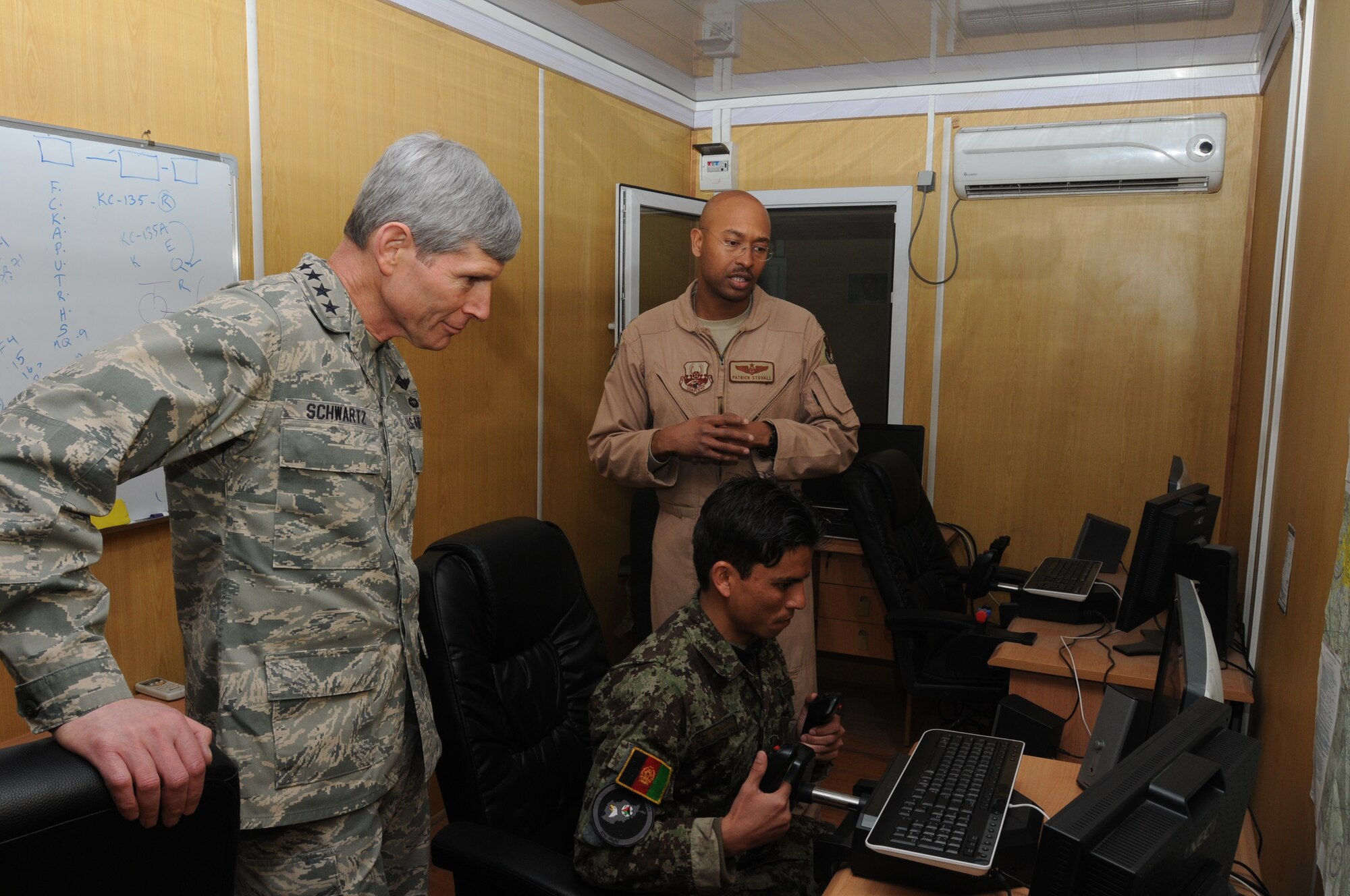 Air Force Chief of Staff Gen. Norton Schwartz observes Afghan Air Force Lt. Jamshid Baryalai demonstrate a simulated flight  during his visit to the English immersion lab known as "Thunder Lab" in Kabul, Afghanistan, on Jan.18, 2011. (U.S. Navy photo/Mass Communications Specialist 3rd Class Petty Officer Jared E. Walker)