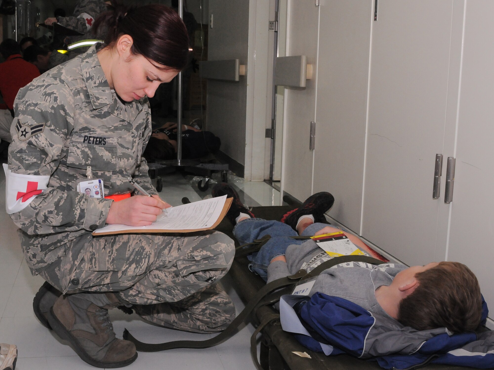 YOKTOA AIR BASE, Japan -- Airman 1st Class Ericka Peters fills out a Patient Movement Record (Air Force Form 3899) here Jan. 19, during a Contingency Aeromedical Staging Facility Exercise. The CASF exercise was held to teach Yokota's medical personnel how to properly process patients for aeromedical evacuations during a crisis. (U.S. Air Force photo/ A1C Katina R. Menchaca)