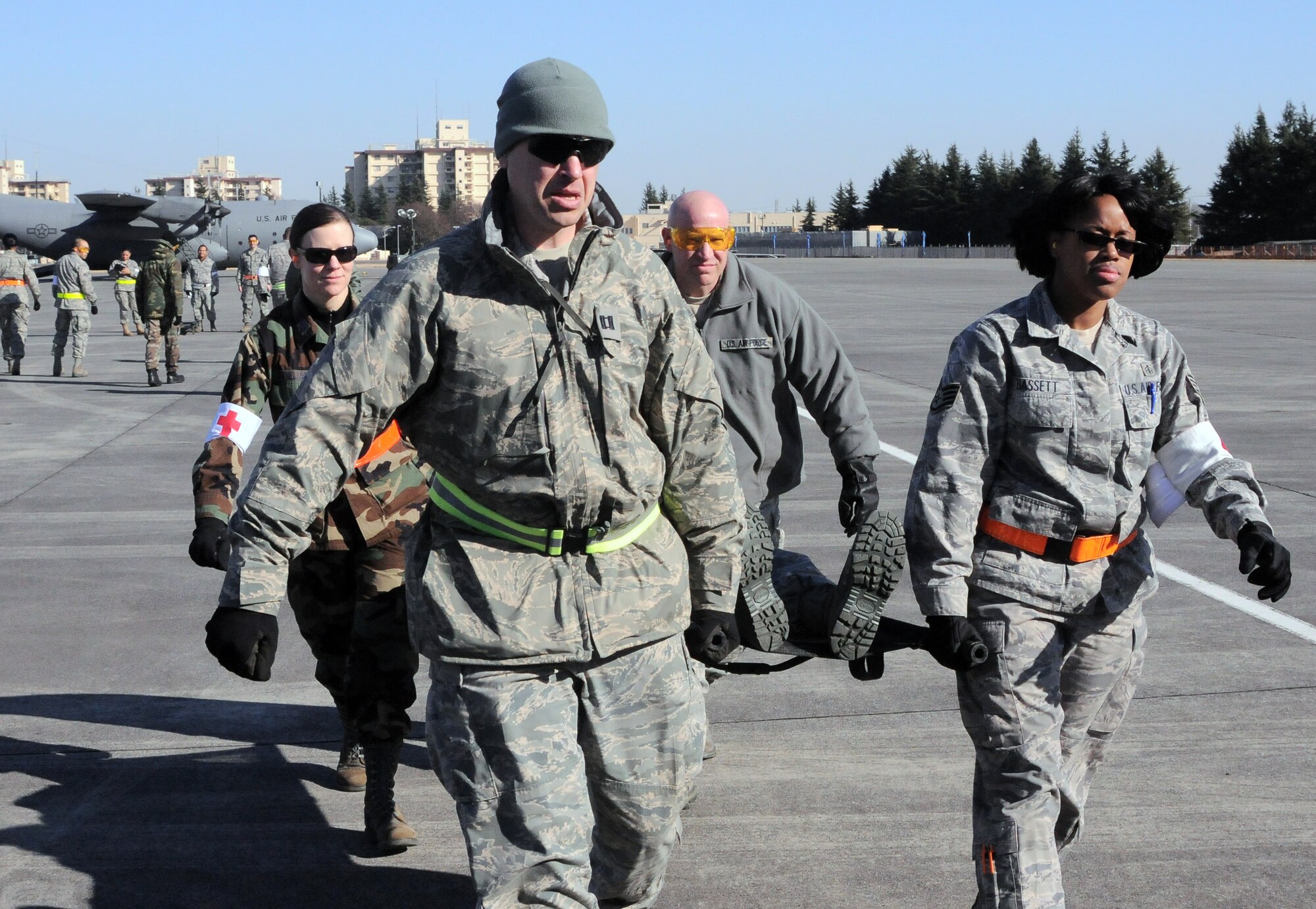 YOKTOA AIR BASE, Japan -- Members of the 374th Medical Group rush a patient to a waiting helicopter for evacuation to another hospital, during a Contingency Aeromedical Staging Facility Exercise, here Jan. 19. The CASF exercise was held to teach Yokota's medical personnel how to properly process patients for aeromedical evacuations during a crisis. (U.S. Air Force photo/ A1C Katina R. Menchaca)